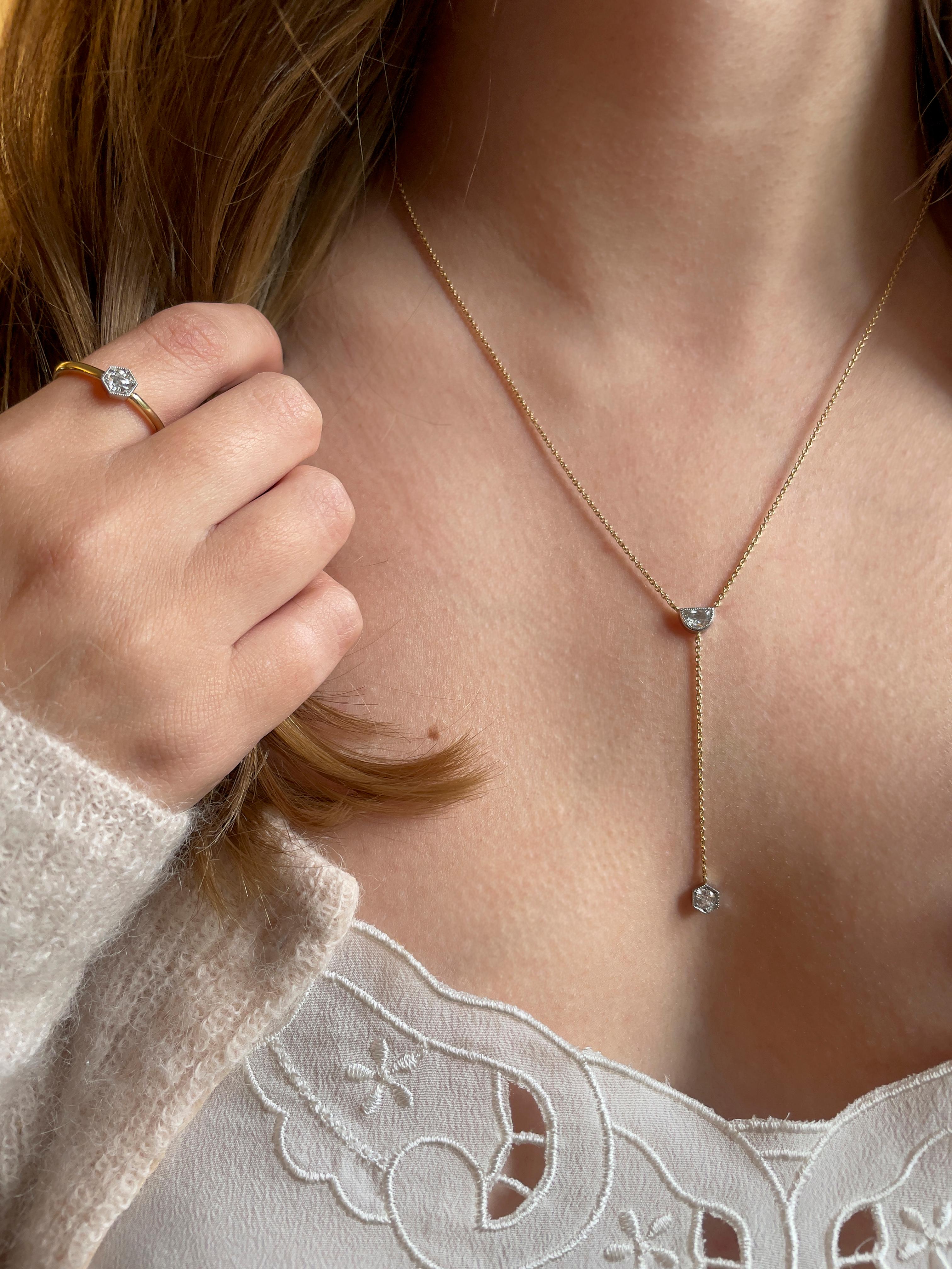 From the Clara collection, the Demi Lune Lariat pendant has been inspired by the geometry and clean lines of the Art Deco period with a modern twist. Both diamonds have been set in platinum with delicate and feminine millegrain detail. The antique