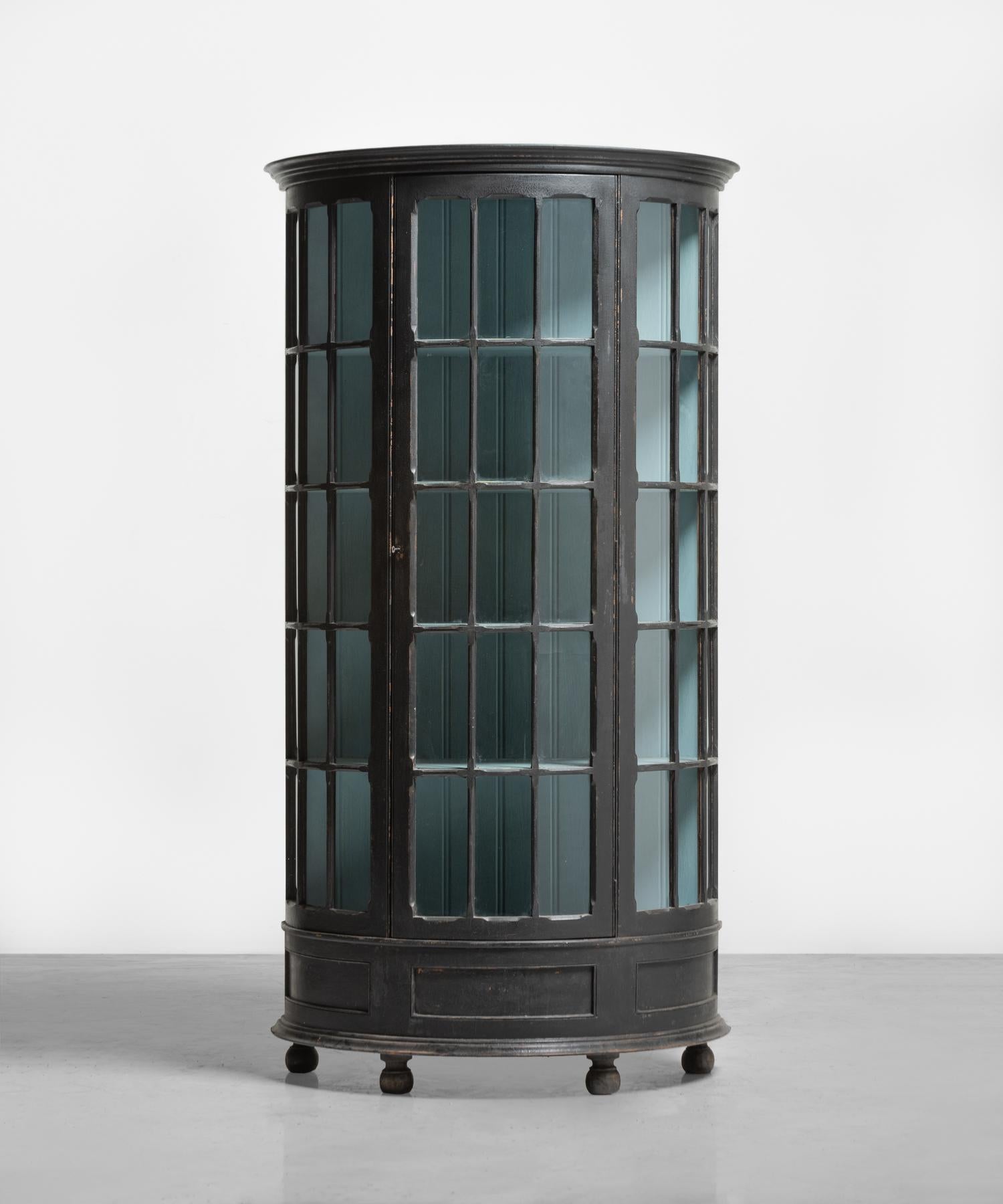 Demi-lune Display Cupboard, England, circa 1900

Unique form, with original ebonised finish on the exterior, and interior robins egg blue paint.