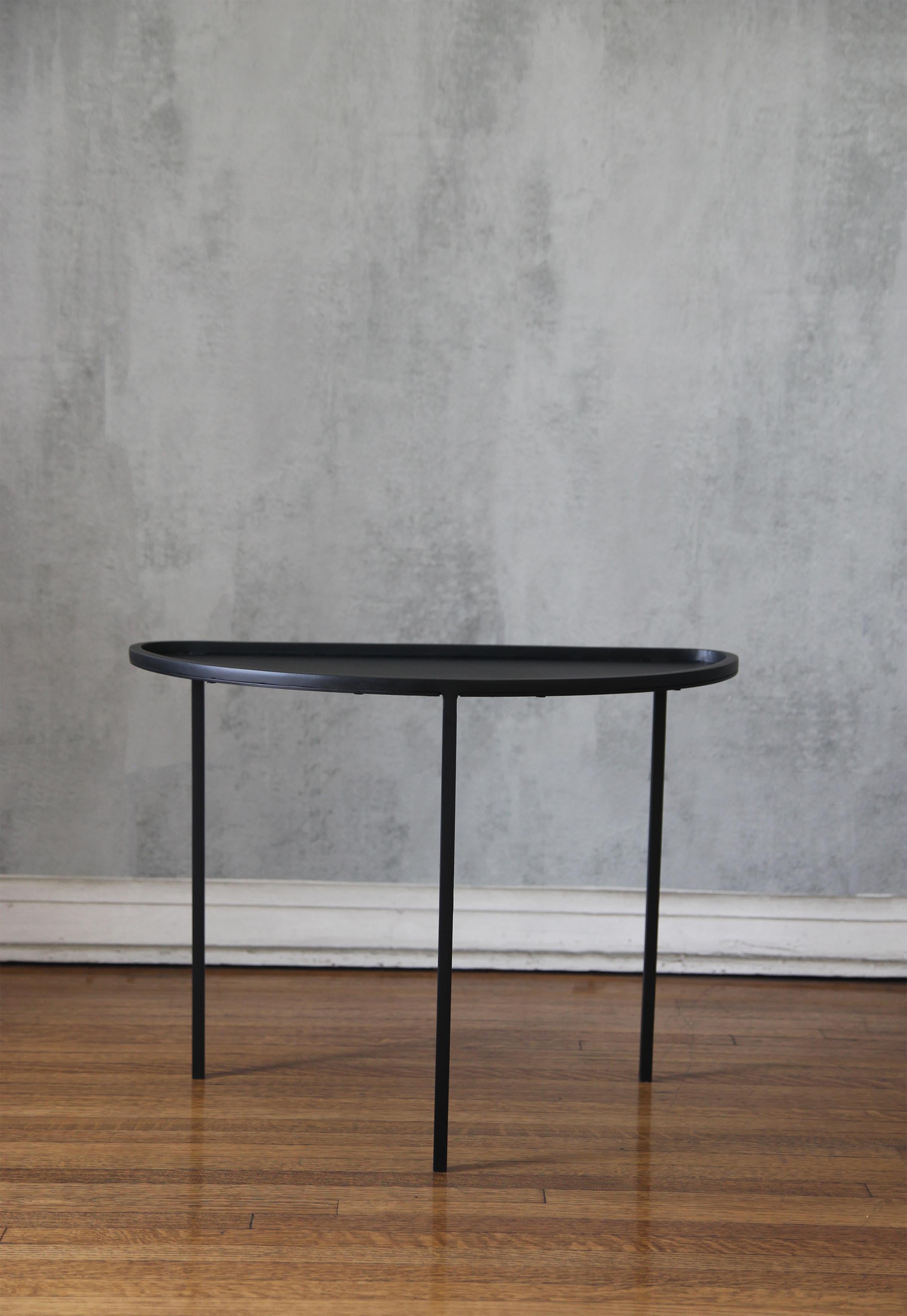 The 'Demi-Lune' from our exclusive Understated Design line. 
Chic slender three Legs blackened iron on a Demi-Lune Curved Black Powder-Coated top. 
Impressive Proportions, Versatile, Understated Elegance.

Custom sizes, finishes are