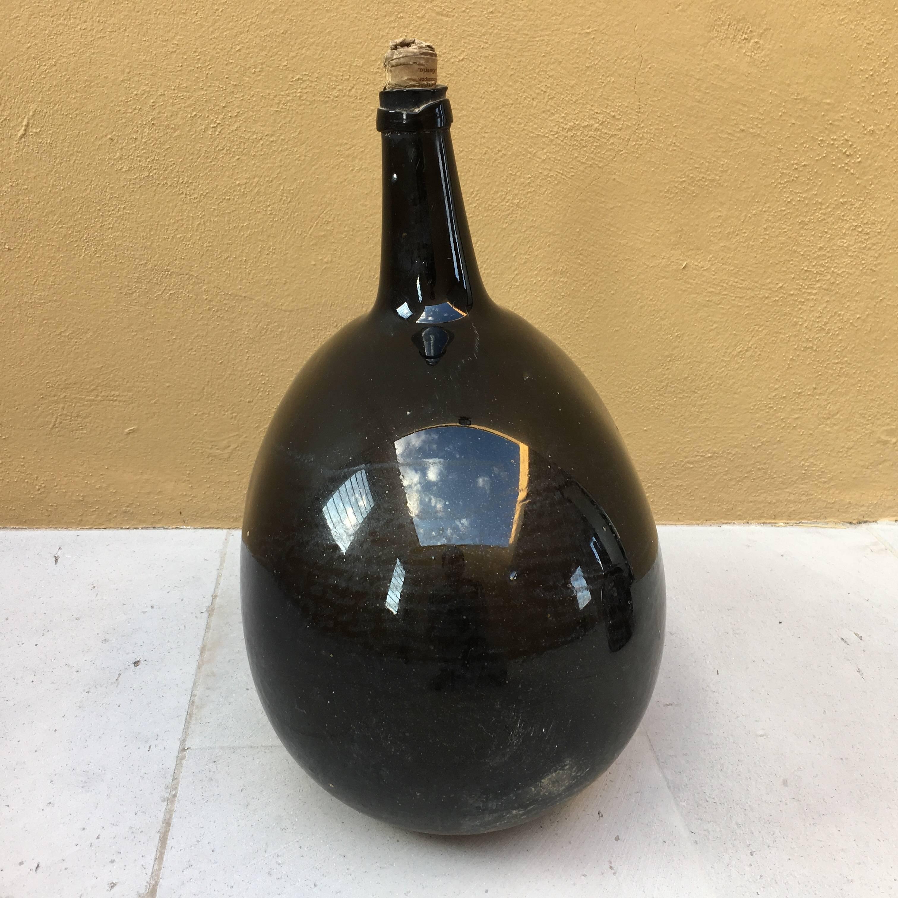 Excellent condition, rare, handblown, non-molded, oval mezcal jug in dark purple glass from Veracruz, Mexico.