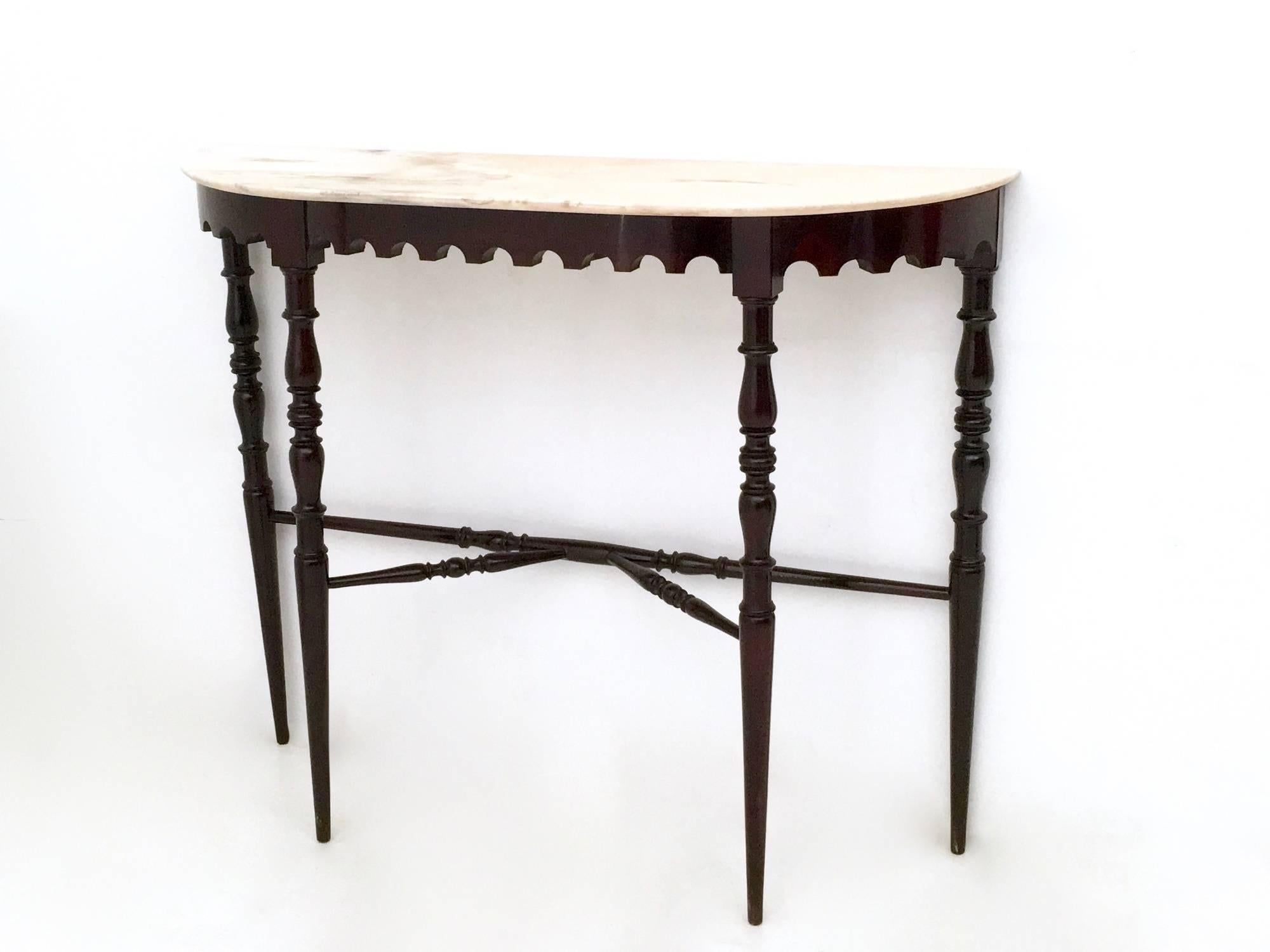 It is made in ebonized beech and features a Portuguese pink marble top.
In excellent original condition and ready to become a piece in a home. 

Measures: Width: 102 cm 
Depth: 30 cm 
Height: 84 cm.