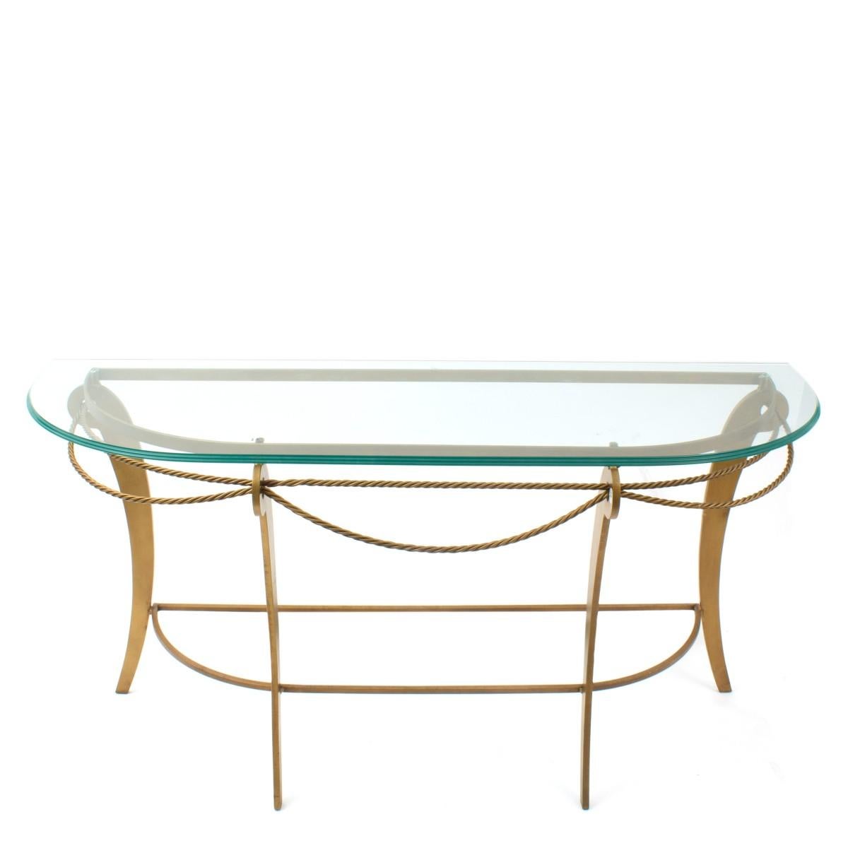 A gold-finished iron demilune shaped console table with glass top and twisted iron rope accents. Imported, circa 2010.