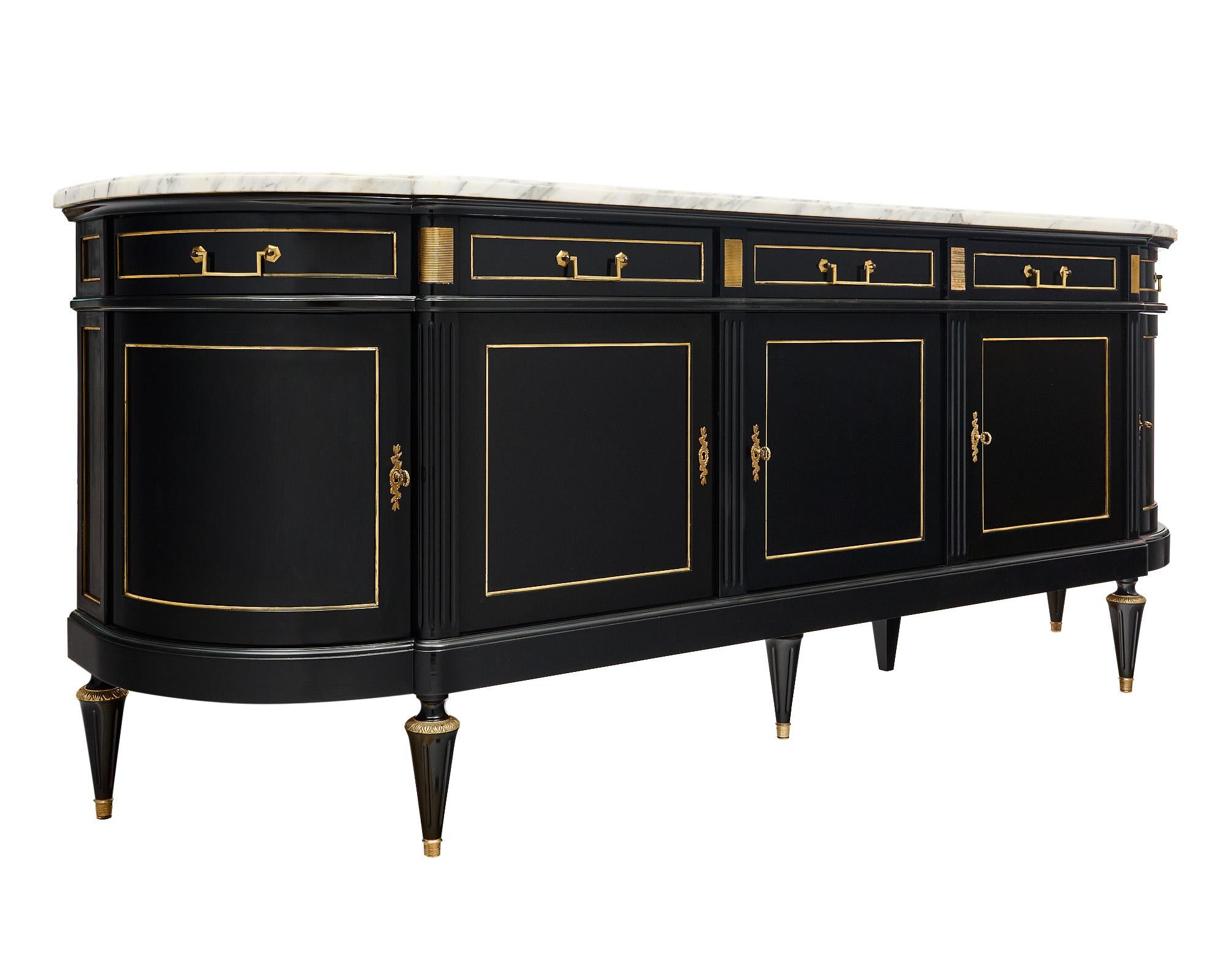 Buffet or enfilade from France made of a solid mahogany that has been finished in a museum-quality French polish for a lustrous effect. There are five doors that open to interior shelving and five dovetailed drawers. The ends have curved doors and