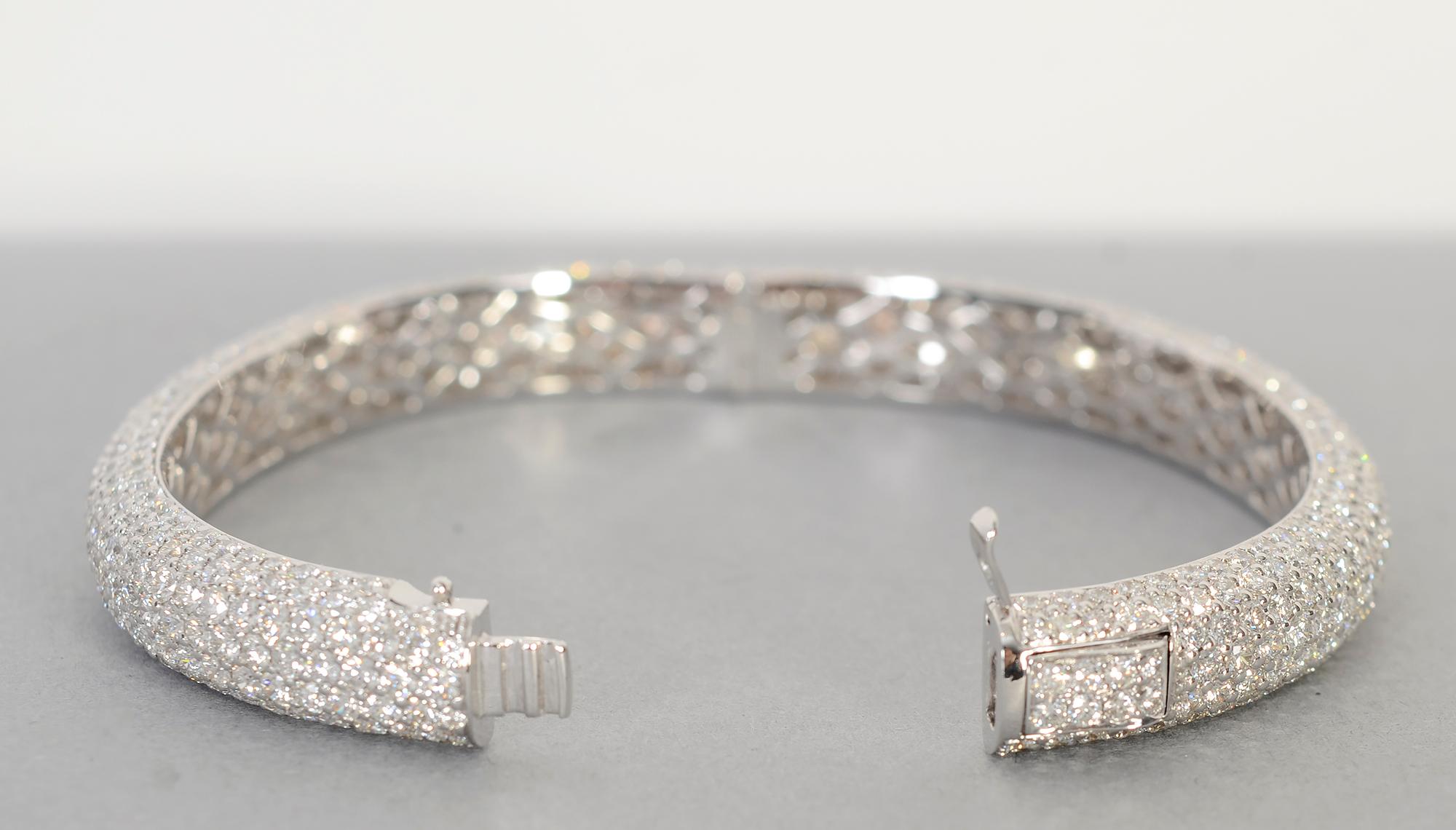 Elegant diamond bangle bracelet by California designer, Dena Kemp. The 638 diamonds go all the way around the bracelet with a total weight of 15.95 carats. The bracelet is 18 karat white gold. It has an inner diameter of 
2 1/2 inches; it is 3/8
