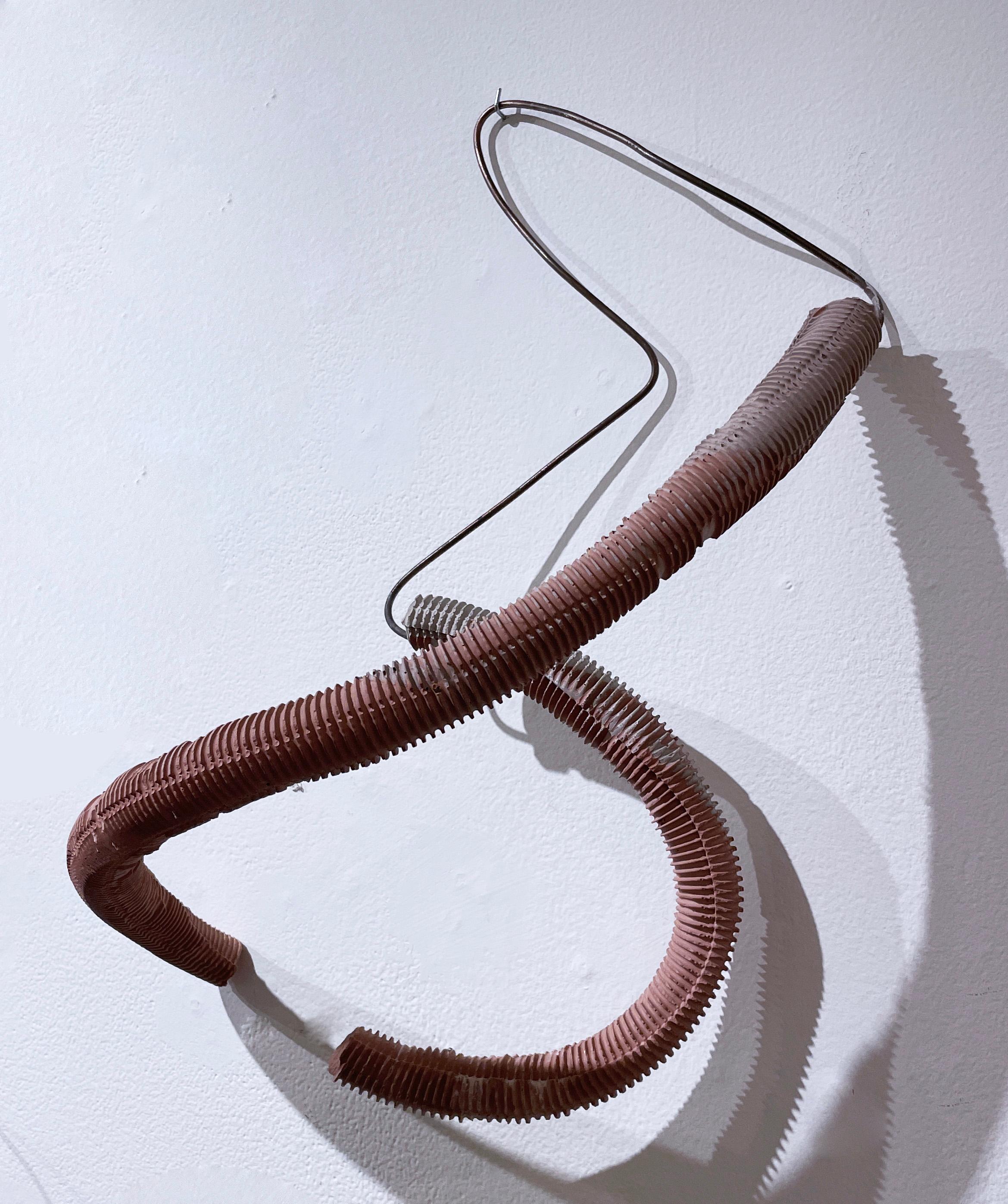 Biomorphic and earthy yet industrial style wall or tabletop sculpture.  Abstract wire form with corrugated hydrocal plaster form.  The piece is smooth and rough, in terracotta or red clay pigmented concrete and metal wire. Abstract geometric and