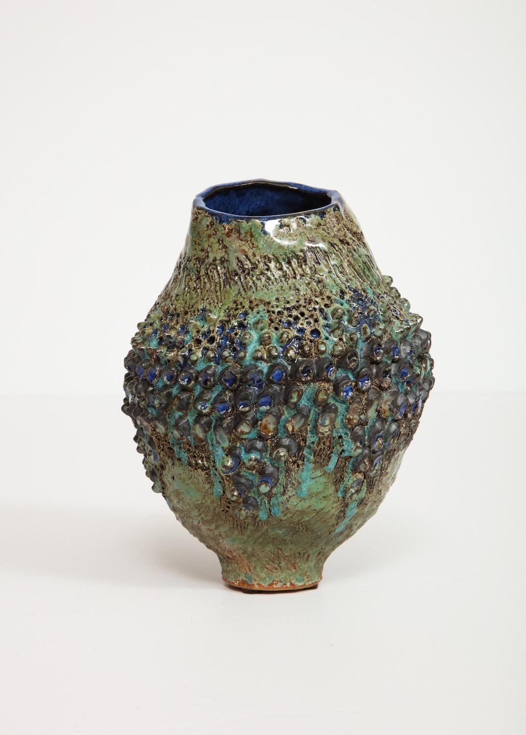 Hand-built irregular form, stoneware vase. Applied texture throughout with vibrant glazes. Artist-signed and dated on underside.