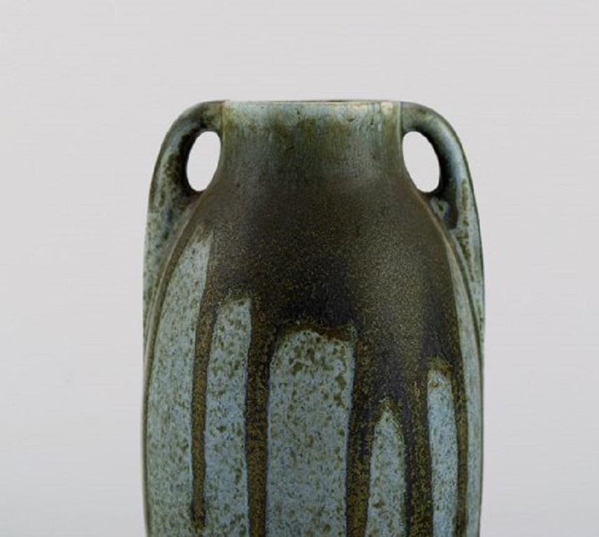 Denbac, France. Vase with handles in glazed ceramic. Beautiful running glaze in shades of blue and green, 1940s.
Measures: 18 x 8.5 cm.
In excellent condition.
Stamped.