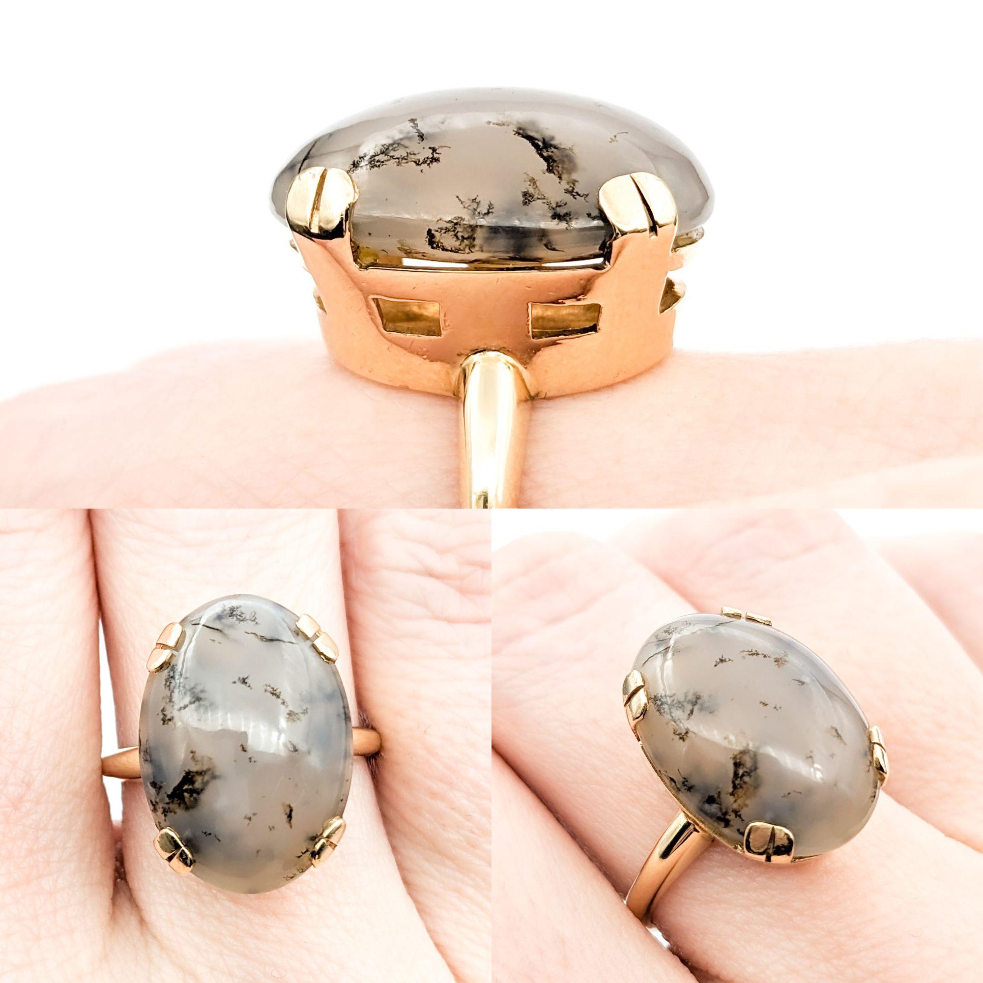 Dendritic Agate & 14K Gold Cocktail Ring 


This distinctive ring, beautifully crafted in 14kt yellow gold, showcases an 8.50ct cabochon dendritic agate, celebrated for its natural, tree-like inclusions that create a captivating landscape within the