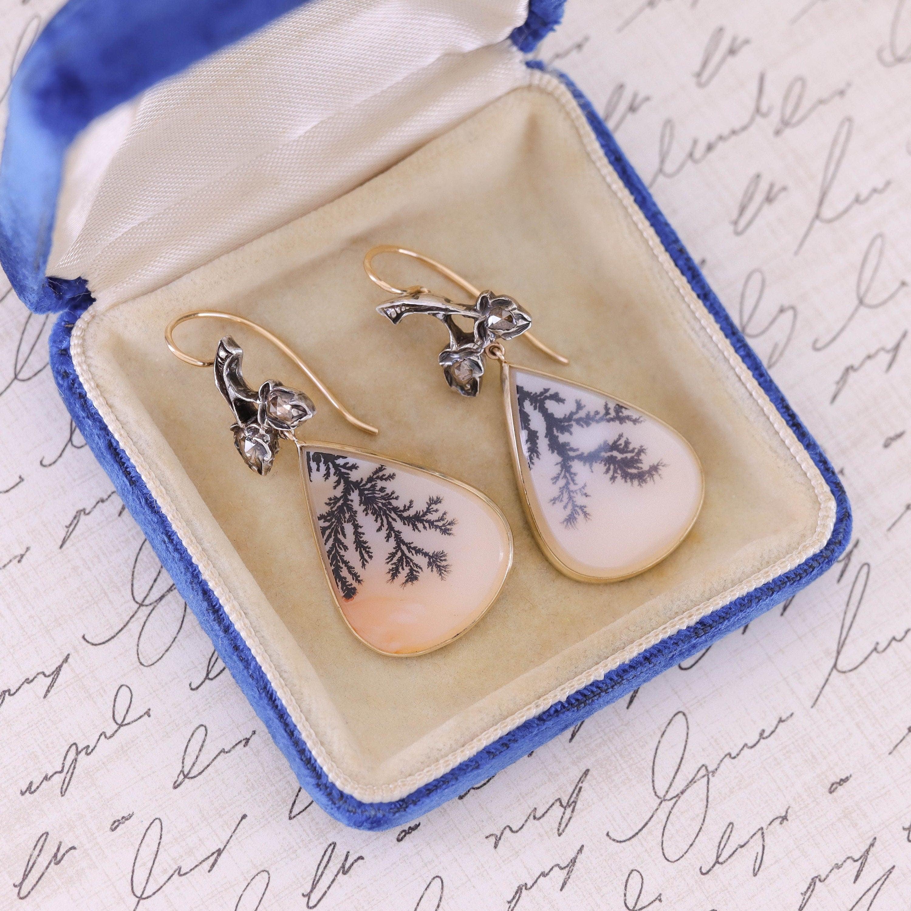 Unique 14k gold earrings featuring diamond leaves above dendritic agate dangles.

The silver topped 14k gold earring surmounts were originally part of a Victorian era brooch (circa 1870) and the dendritic agate dangles are new.

Each earring