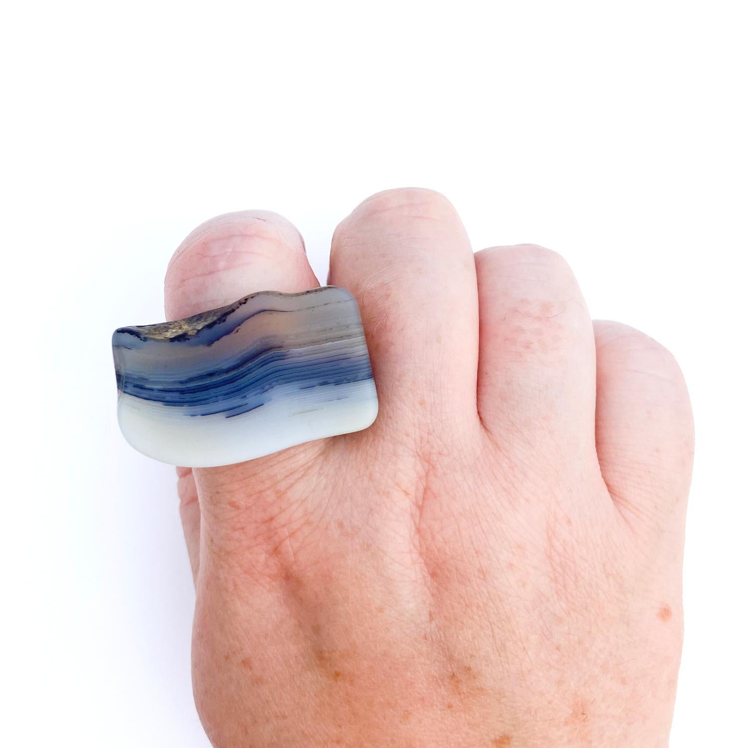 I love the translucent waves in this ring and how it starts to crimp at the end. The lines are so cool!

Each ring is made slowly by Marge out of larger pieces of stone that takes over a month to carefully carve, shape and, refine into this