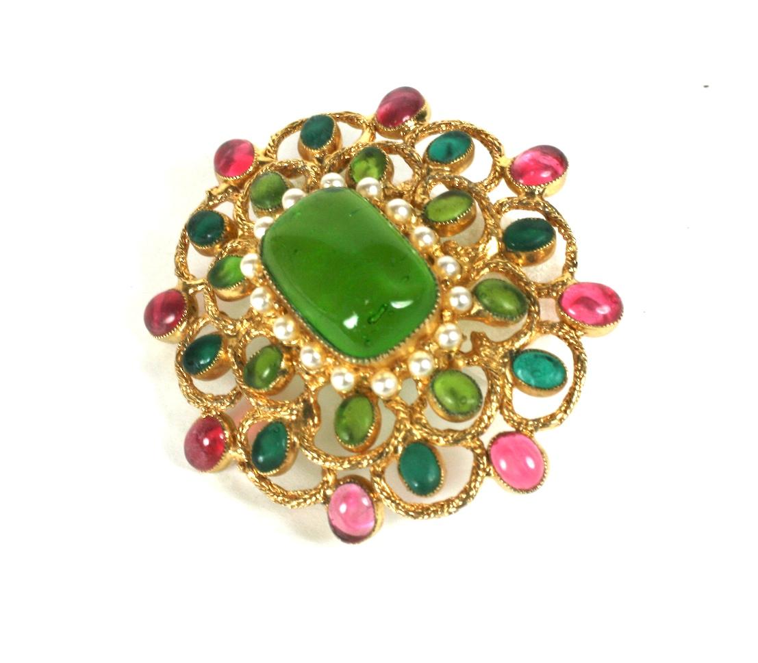 DeNicola Gripoix dimensional brooch of emerald, pale emerald and pale rose poured glass with faux pearl accents with unusual braided chain bezels. Many American companies contracted Gripoix in the period to produce their items as the process was