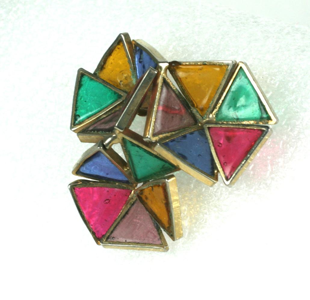 DeNicola Poured Glass Brooch made to look like stain glass Modernist flowers. In the period, DeNicola contracted French houses for manufacture so this brooch is produced by Gripoix. 
Very few designs were made for this American company in this