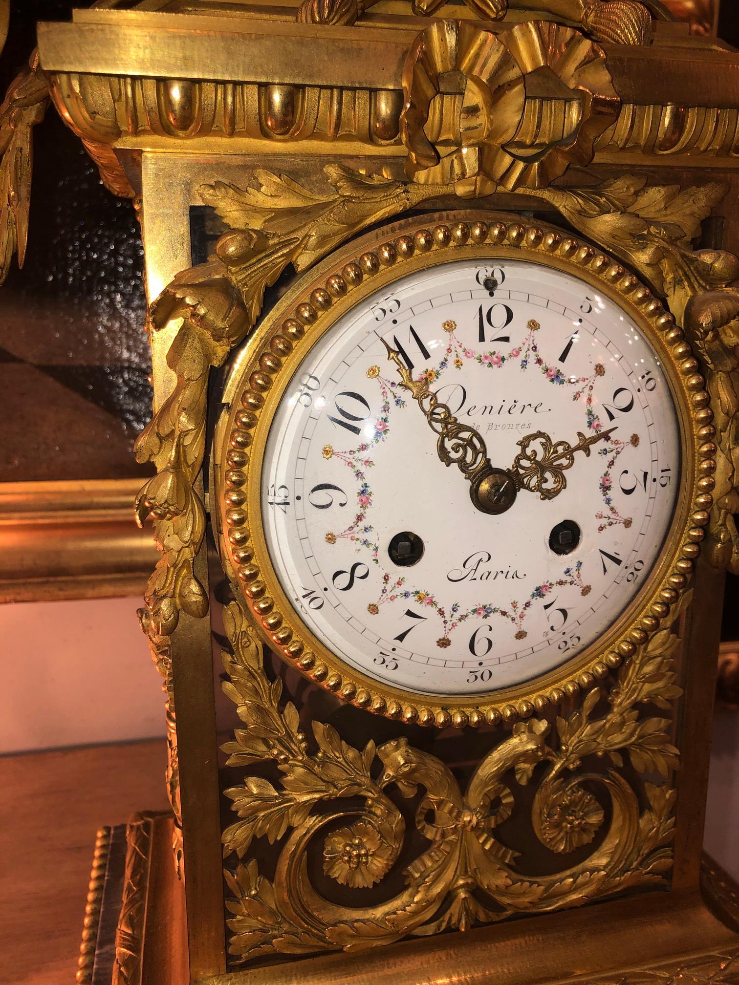 Deniere Gilt Bronze Mantle Clock in the Louis XVI taste. The case Jean Francois/ Guillaume Diniere (French 1820-1901) circa 1870, finely cast gilt bronze and marble mantle clock in the Louis XVI taste, surmounted by a ribbon tied quiver & torch. The
