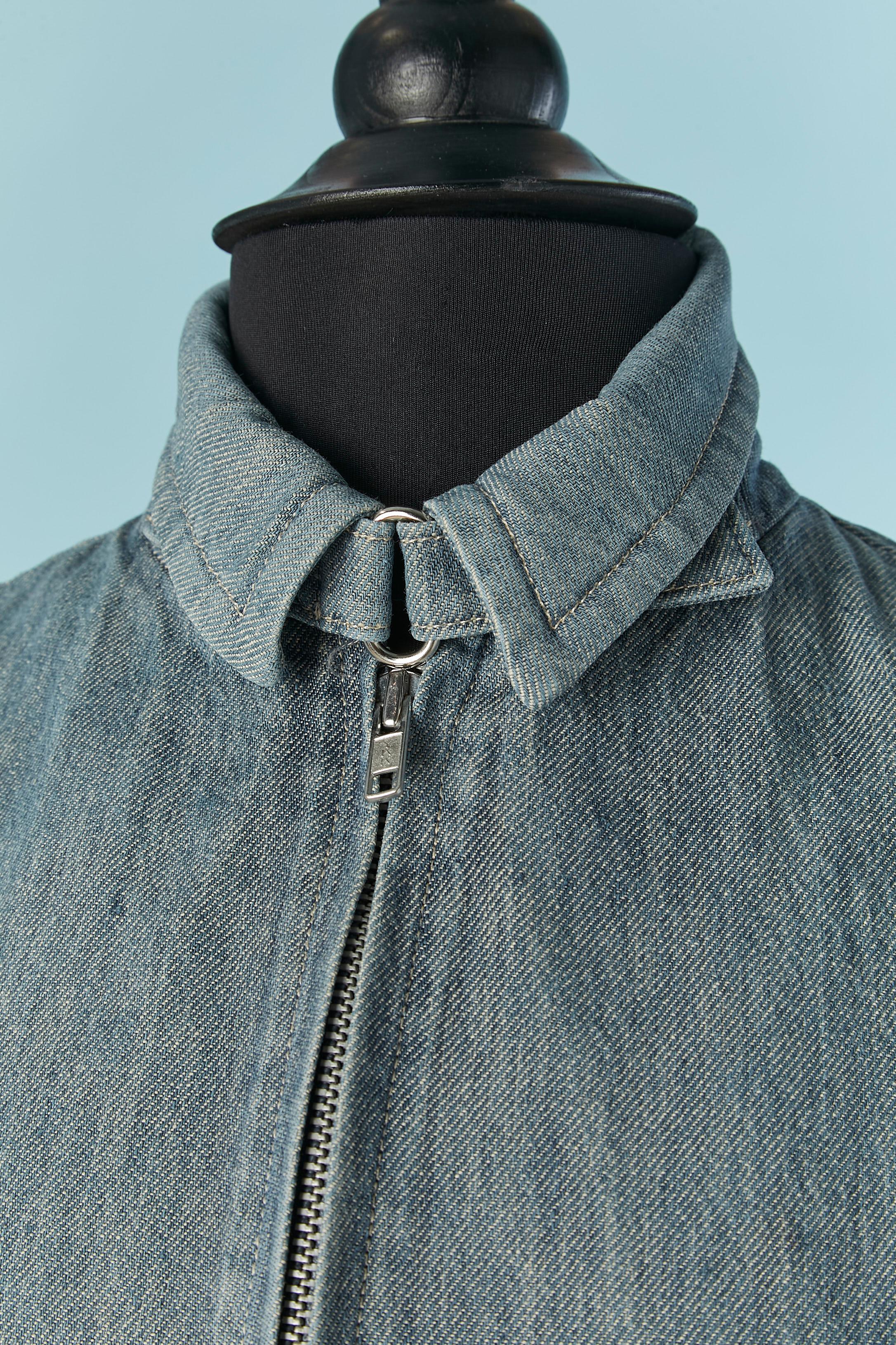 Denim jacket and skirt ensemble. 
Zip closure on the middle front of the jacket with buckle and strap on the waist and on the collar. 
Pocket on both side. 
SIZE 38 (Fr) M 