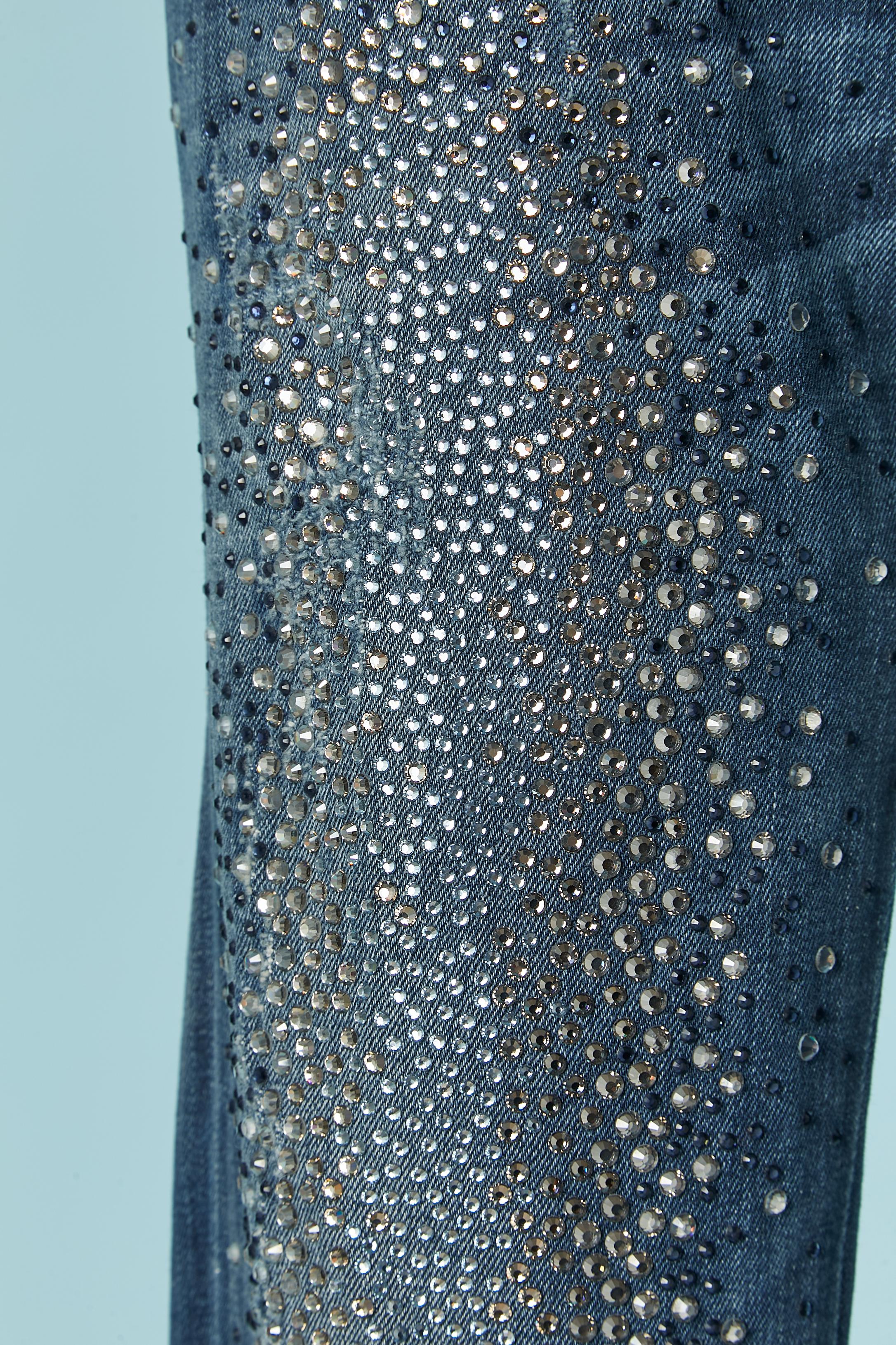 Denim-Jeans mit Strass-Verzierung und Löchern (von der Designerin hergestellt) Stoffzusammensetzung: 98% Baumwolle, 2% Stretch. 2 Taschen auf der Vorderseite und 2 auf der Rückseite mit Markennieten. Markenknopf, Knopfloch und Reißverschluss in der