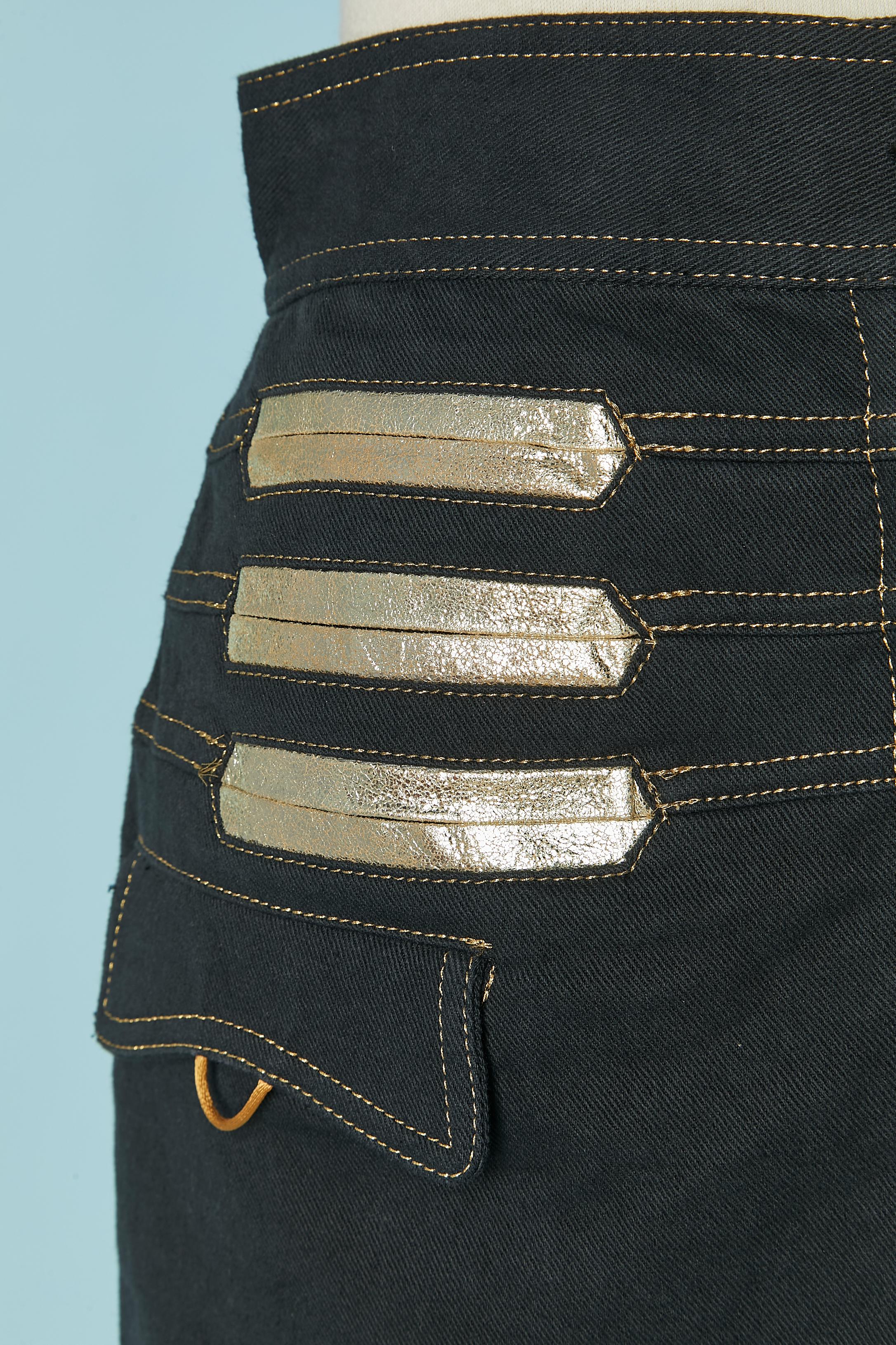 Denim mini-skirt with gold leather details . Button and buttonhole closure on the middle front + zip. Pocket on both side and on the back with leather edge. 
SIZE M 