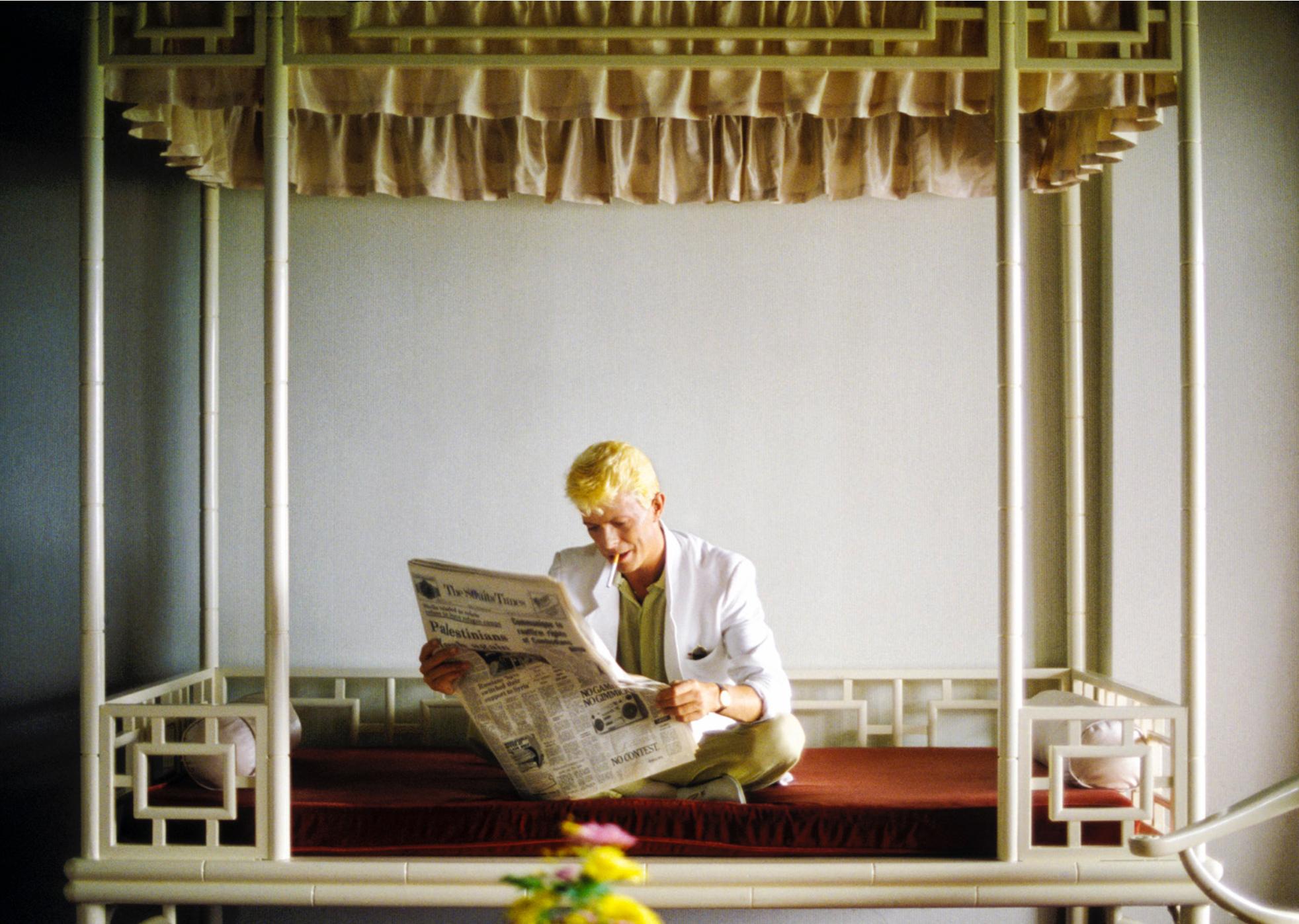 Fine art 20x24" print of David Bowie in his hotel room reading a newspaper in Singapore, 1983 during the Serious Moonlight Tour by acclaimed photographer, Denis O'Regan

Printed to order on Hahnemühle Photo Rag 308gsm
Fine Art Paper by a Hahnemühle