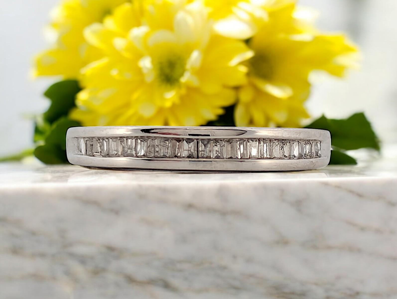 The Denise Band is a symbol of elegance and refined luxury, crafted from 14k white gold and adorned with .52 carat total weight (ctw) of baguette-cut diamonds. The diamonds are set halfway around the band, offering a striking yet subtle sparkle.