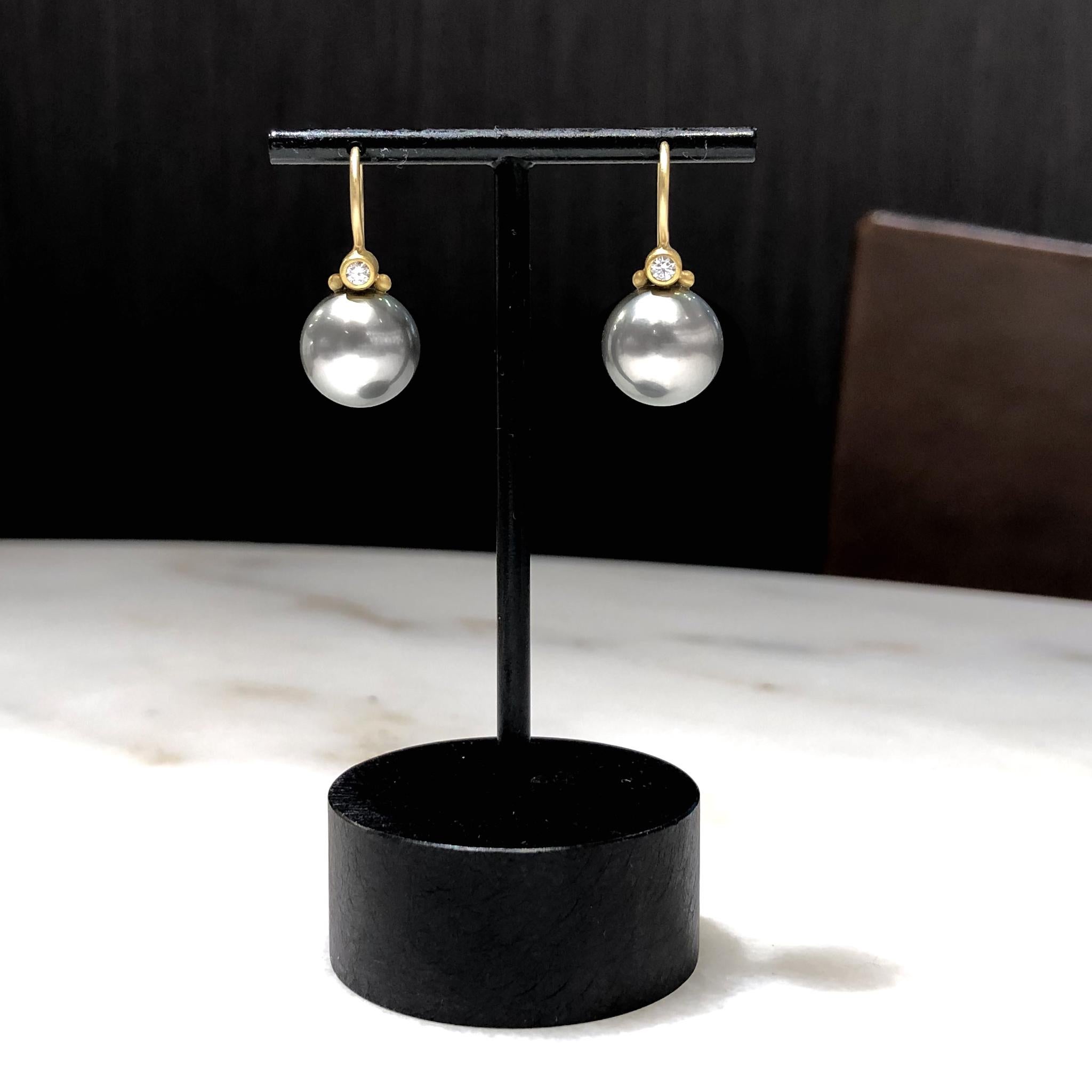 Drop Earrings handmade by jewelry artist Denise Betesh in her signature matte-finished 22k yellow gold featuring a matched pair of lustrous 11mm deep gray Tahitian pearls invisibly-set beneath 0.10 total carats of round brilliant-cut white diamonds