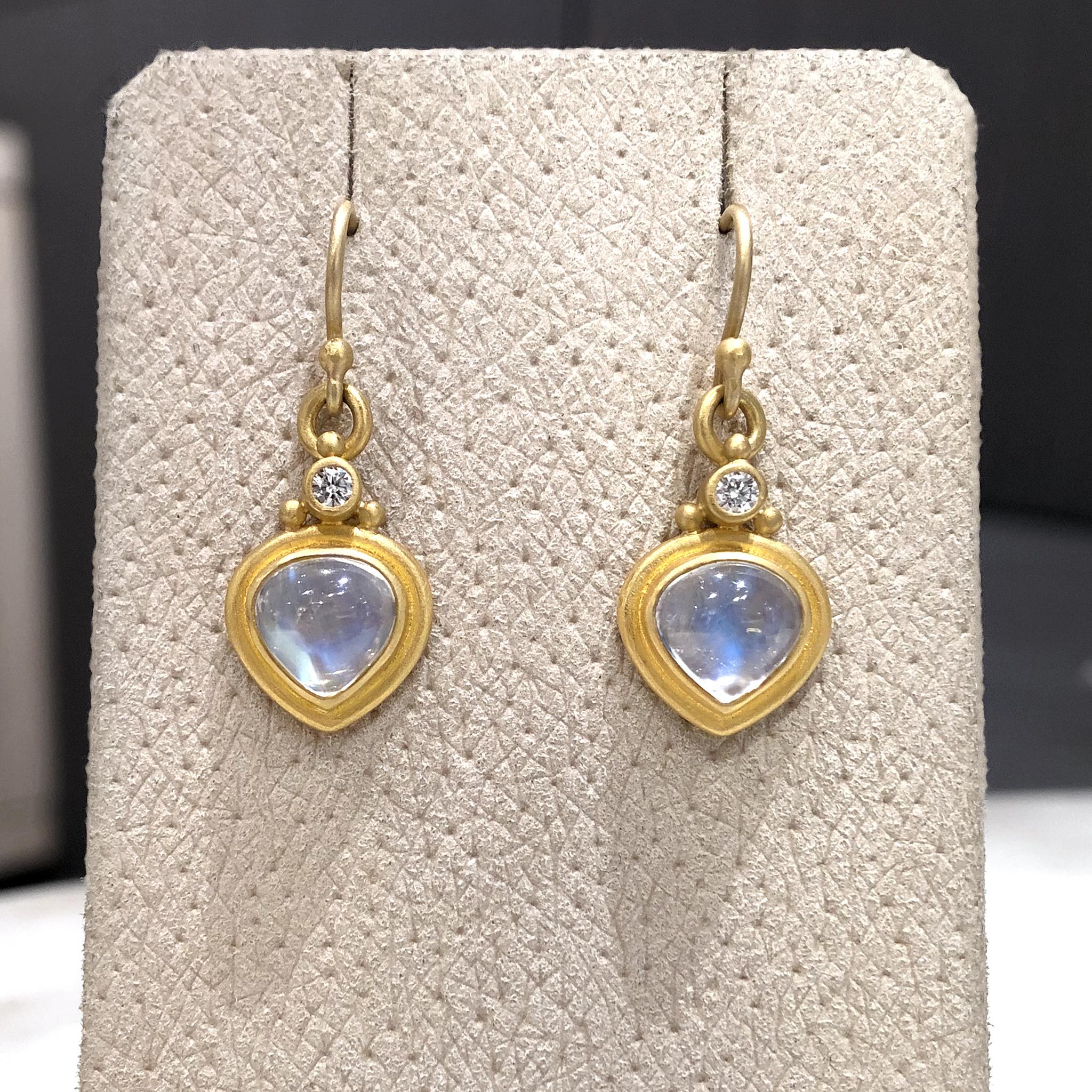 One of a Kind Drop Earrings hadcrafted by jewelry maker Denise Betesh featuring a matched pair of sensation blue moonstone tabiz cabochons totaling 3.50 carats framed in the artist's signature matte-finished 22k yellow gold accented with 0.10 total