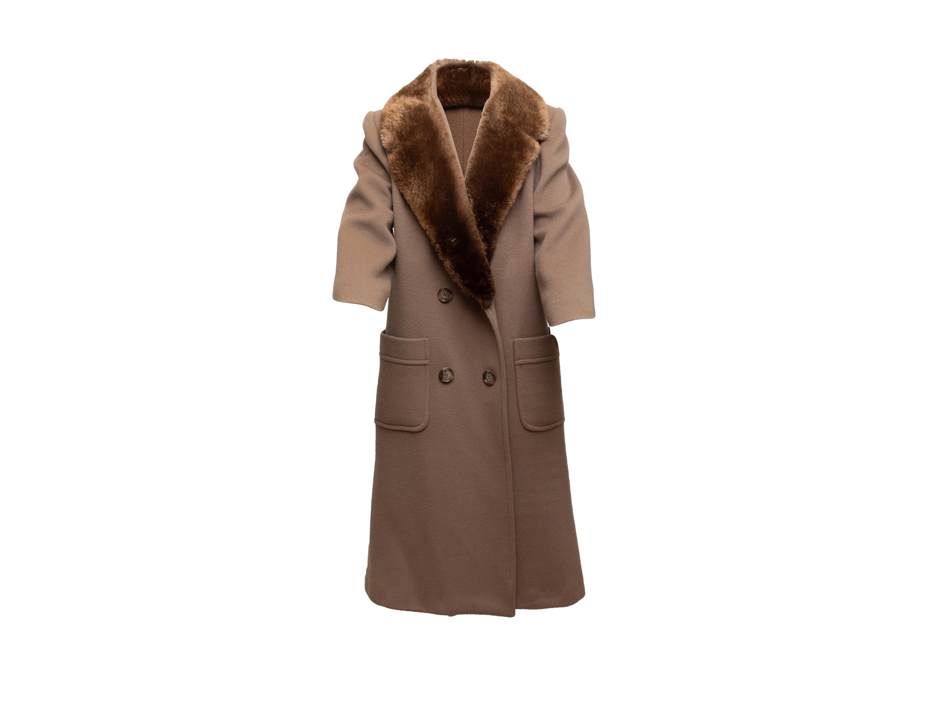 Product details: Vintage light brown wool double-breasted coat by Denise For Windermere. Notched fur-trimmed lapel. Dual patch pockets at hips. Button closures at front. 42
