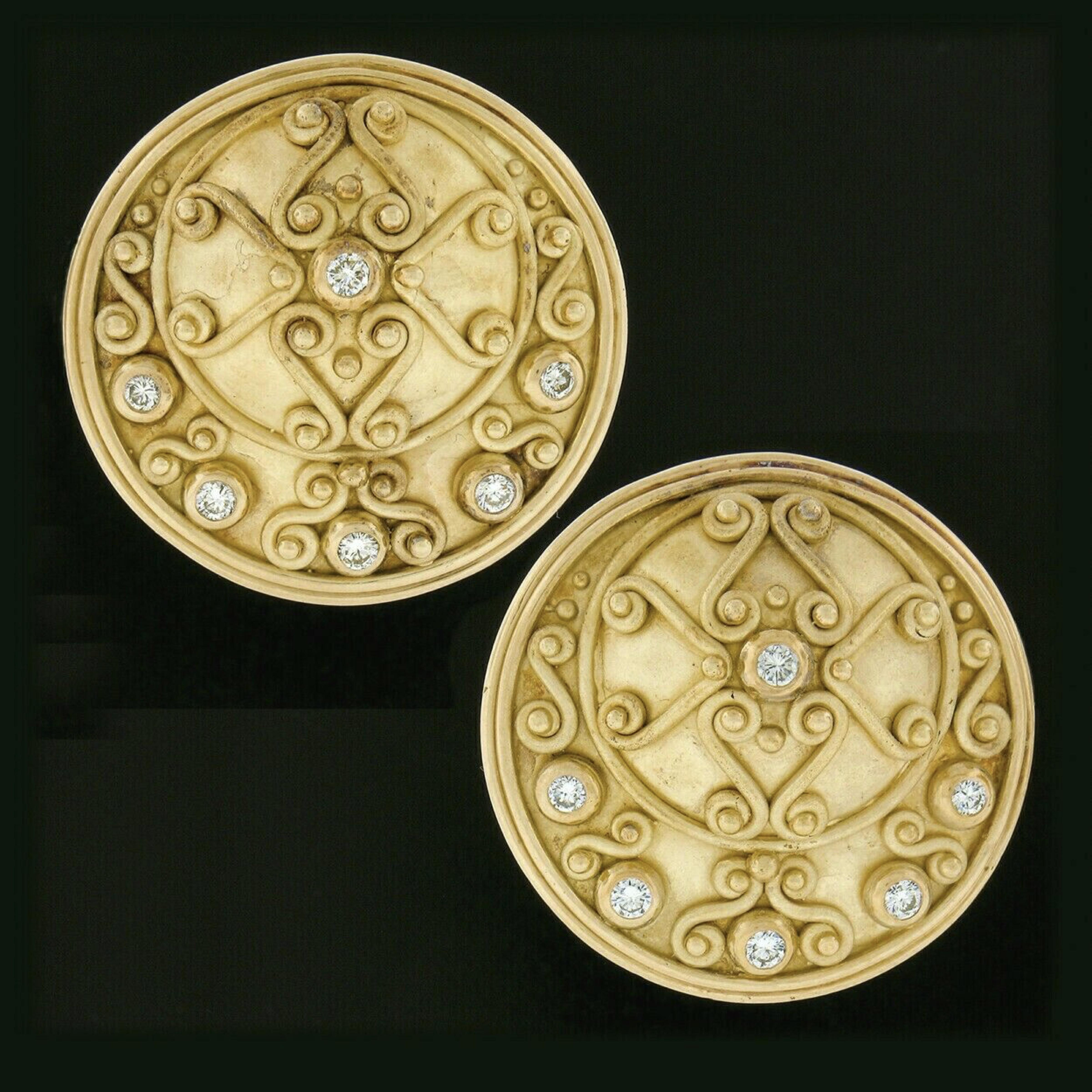 Here we have a gorgeous pair of statement earrings designed by Denise Roberge and crafted in solid 18k yellow gold. They feature a large round disc with a slightly domed area, all of which is elegantly decorated with gold work in a lovely Etruscan