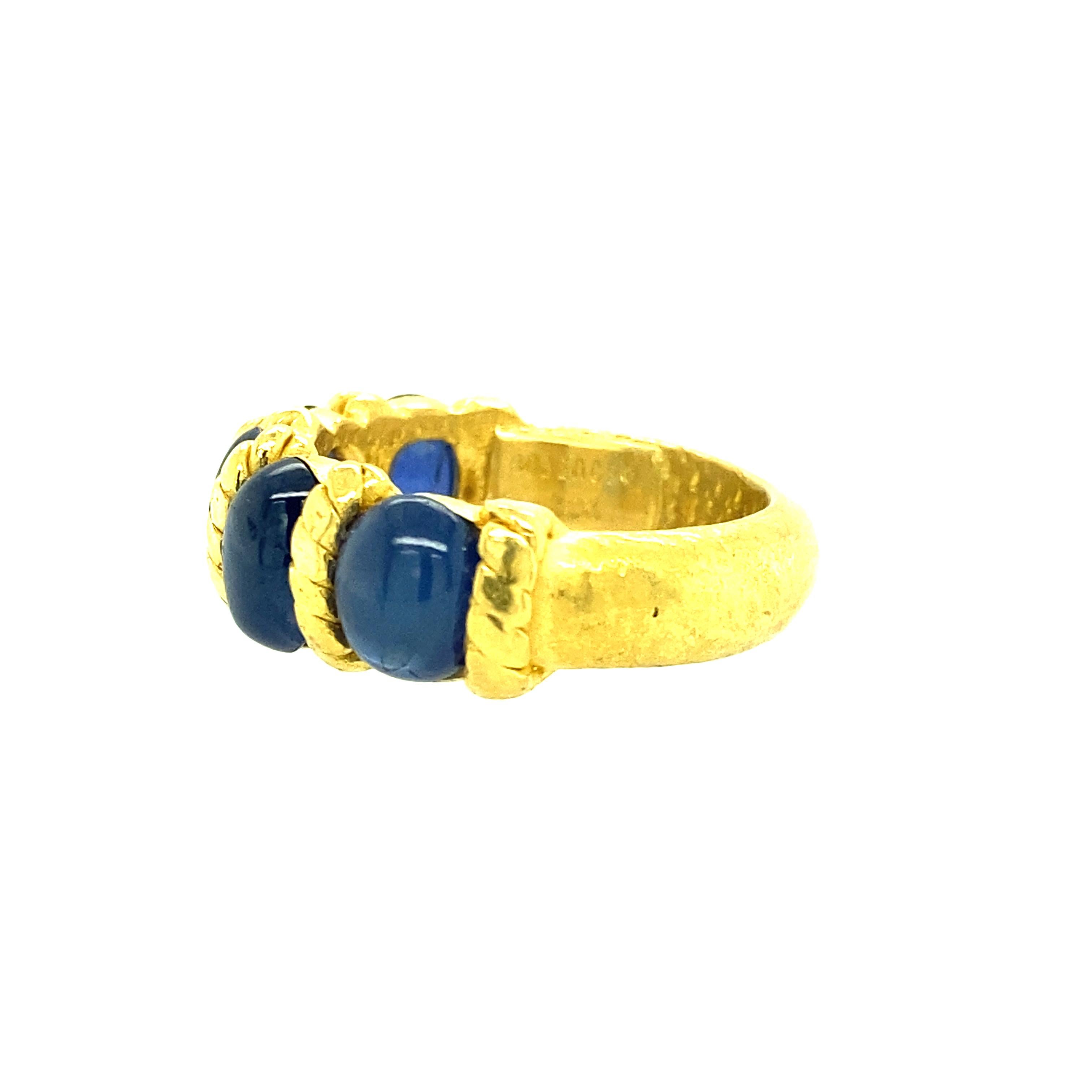 One 22 karat yellow gold (stamped 22K) ring set with five 7X5 natural blue oval sapphires by Denise Roberge.  The shank measures 5.17mm near the top of the ring and tapers to 5.03mm at the base. The ring weighs 13.66 grams and is a finger size 7.75.
