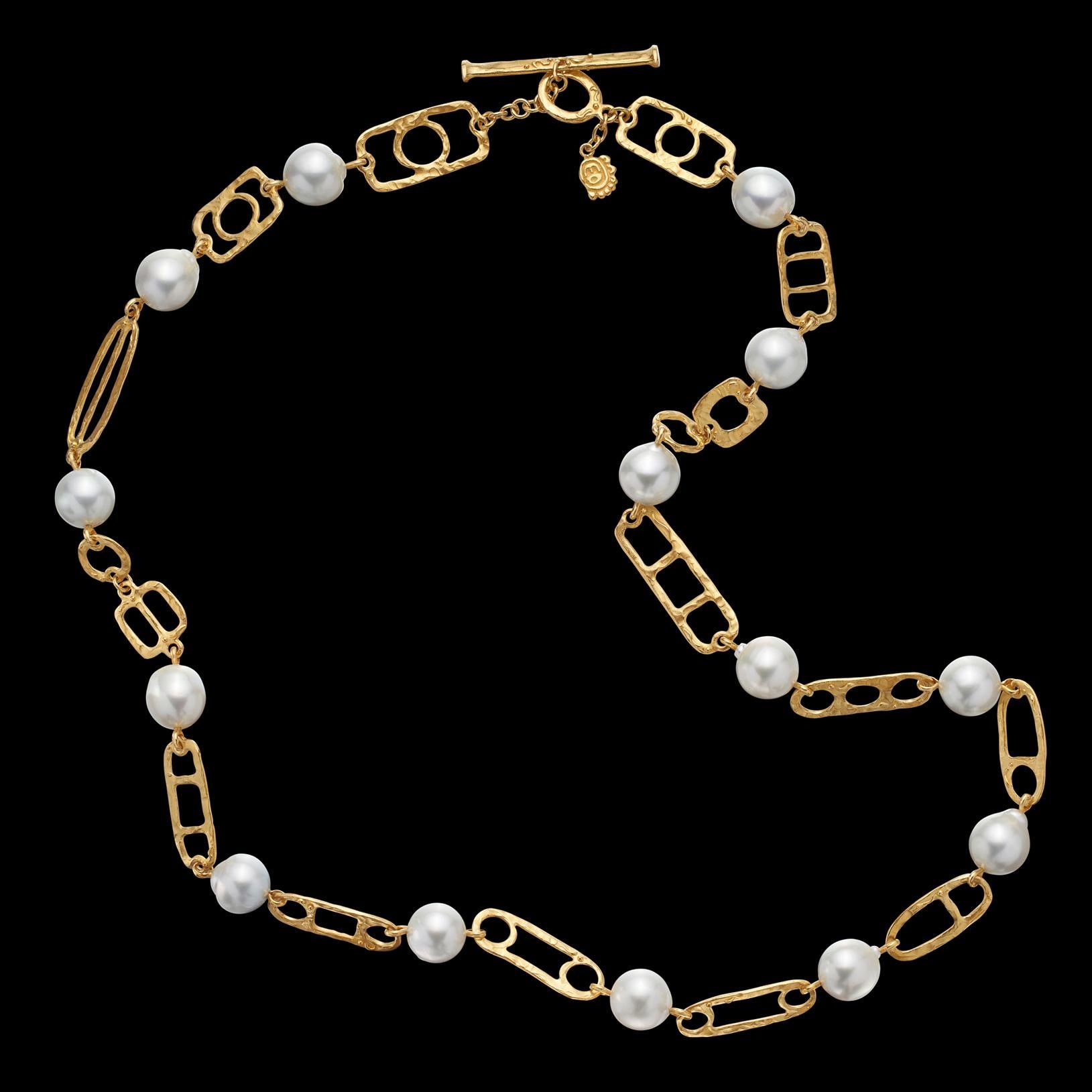 A handcrafted beauty! This 22k gold necklace by noted designer Denise Robergé is both unique, fun and a statement piece. Designed with variously shaped gold links, highlighting 14 semi-baroque, lustrous silver-white South Sea cultured pearls,