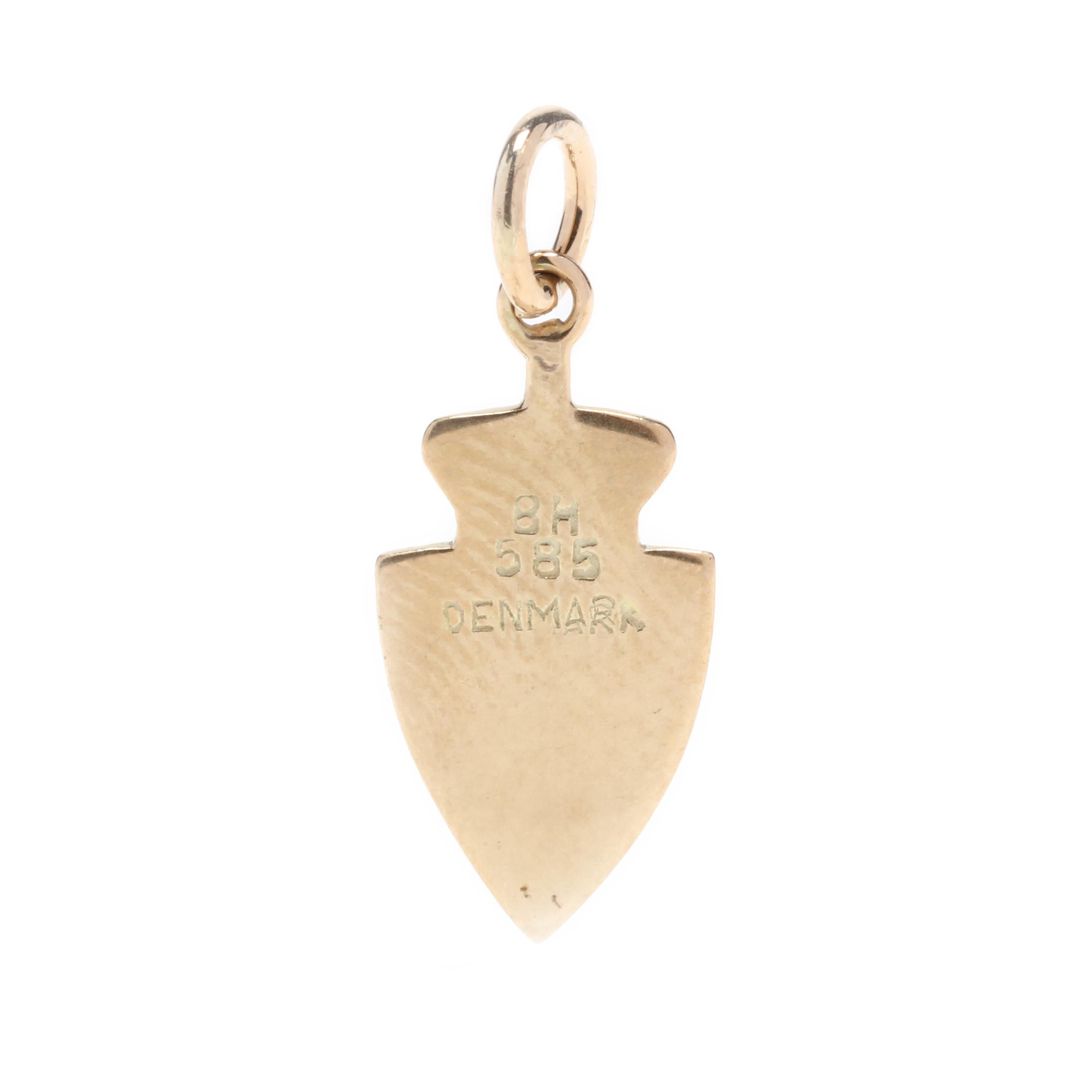 A vintage 14 karat yellow gold Denmark coat of arms charm. This small charm features  an engraved crown motif sitting atop a shield shape with the enameled coat of arms of Denmark and with a thin bail.

Length: 3/4 in.

Width: 3/8 in.

Weight: .80