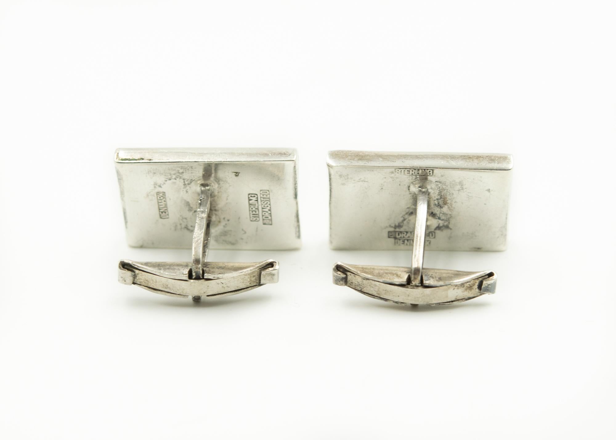 Mid 20th century modern cufflinks made by Danish silversmith E. Dragsted.  These elegant rectangular sterling silver cufflinks resemble a wave.  They have a whale tail back.

E. DRAGSTED
Dragsted had a workshop in Copenhagen 1948-1958.