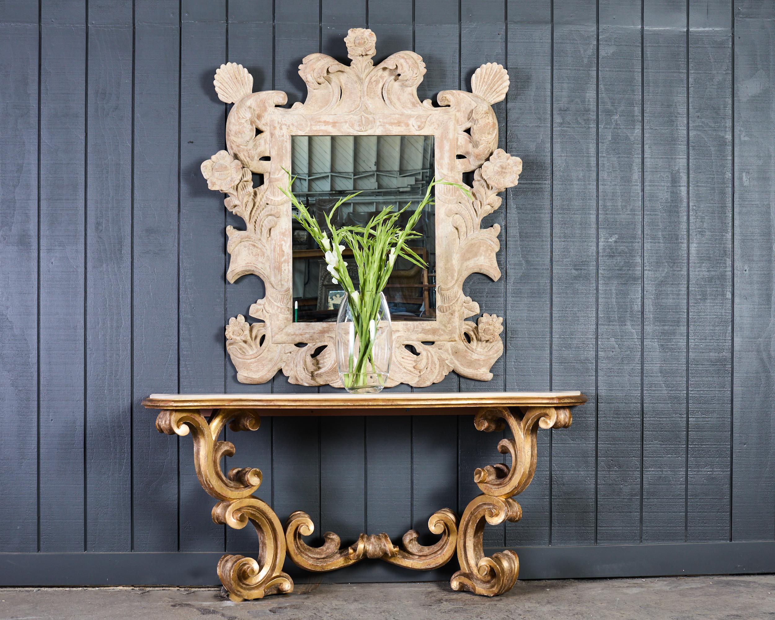 Opulent baroque style console table featuring a honed French limestone top designed by Dennis and Leen Hollywood, CA. The dramatic table measures over 6 feet long. The thick French limestone top has a gracefully scalloped, or serpentine form with a