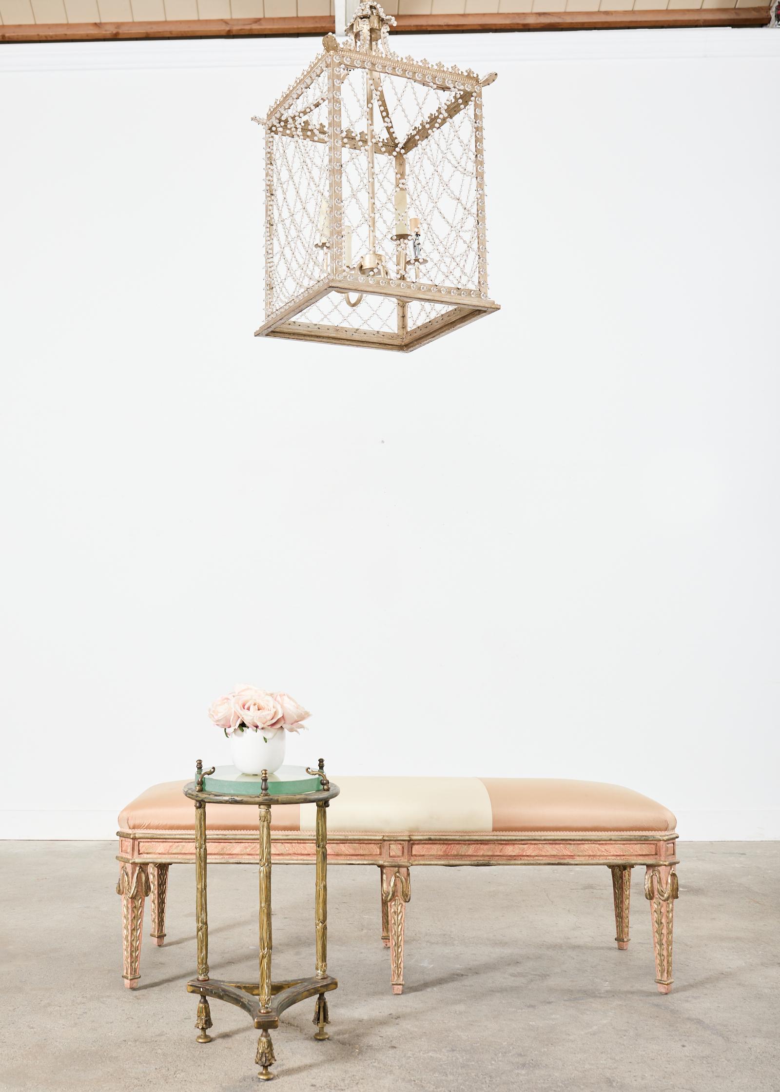 Opulent upholstered painted bench seat designed by Dennis & Leen Hollywood, CA. The grand bench features a large beech frame carved in the neoclassical or Louis XVI taste. The frame is painted and intentionally aged with parcel gilt accents. The