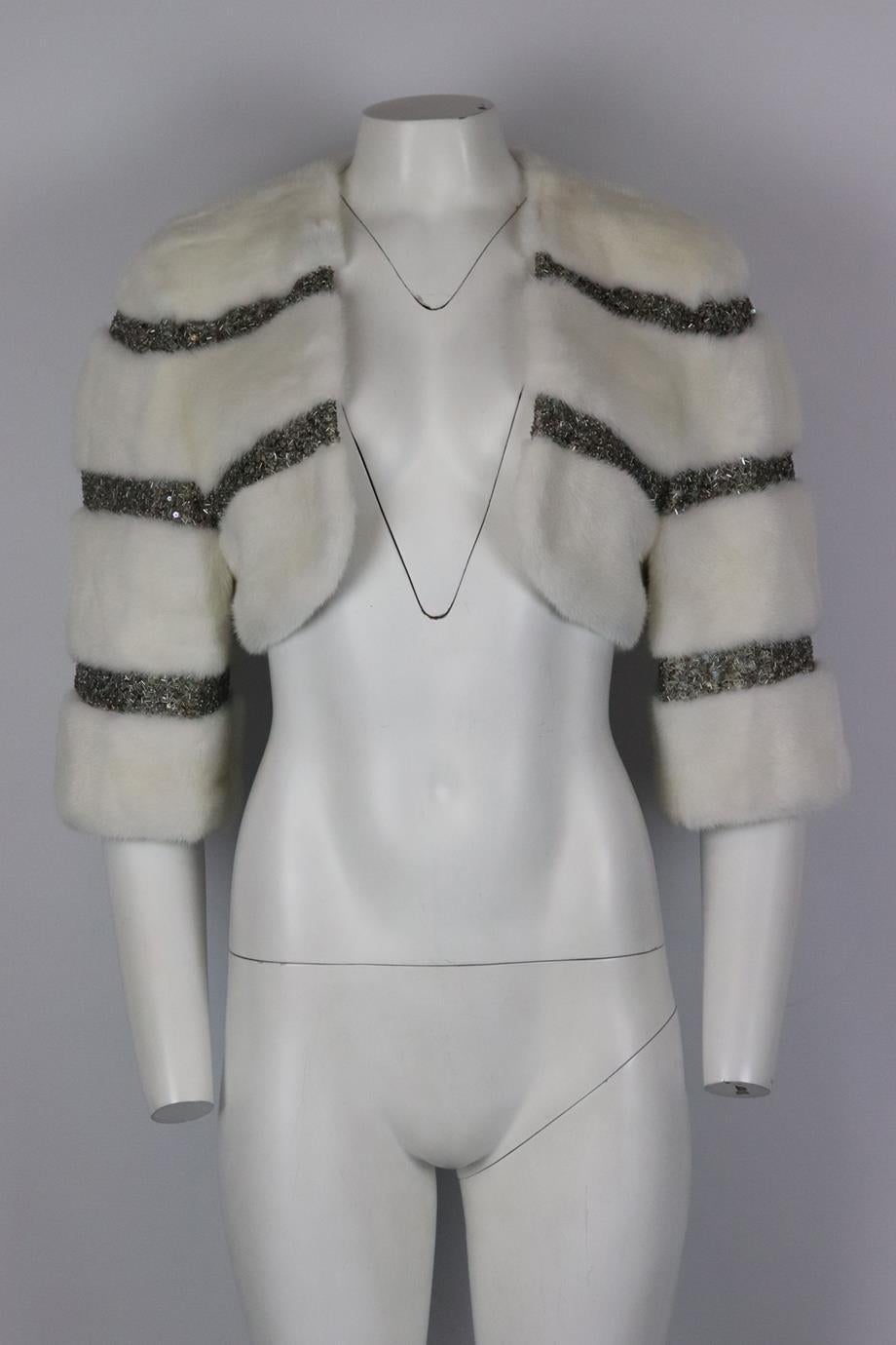 Dennis Basso cropped embellished mink fur jacket. Ivory. Short sleeve, v-neck. Slips on. Size: UK 14 (US 10, FR 42, IT 46). Shoulder to shoulder: 17 in. Bust: 38 in. Length: 12.5 in. Very good condition - Marks to interior lining; see pictures