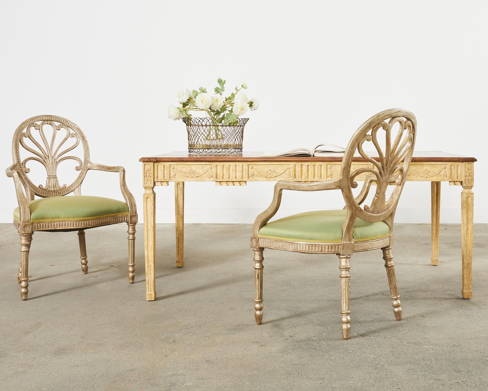 Exquisite library table or desk designed by Dennis & Leen Los Angeles, CA. Known as the Belgian Louis XVI table it features neoclassical style motifs on the apron and legs. Decorated with carved swag and rosettes having an aged, distressed painted