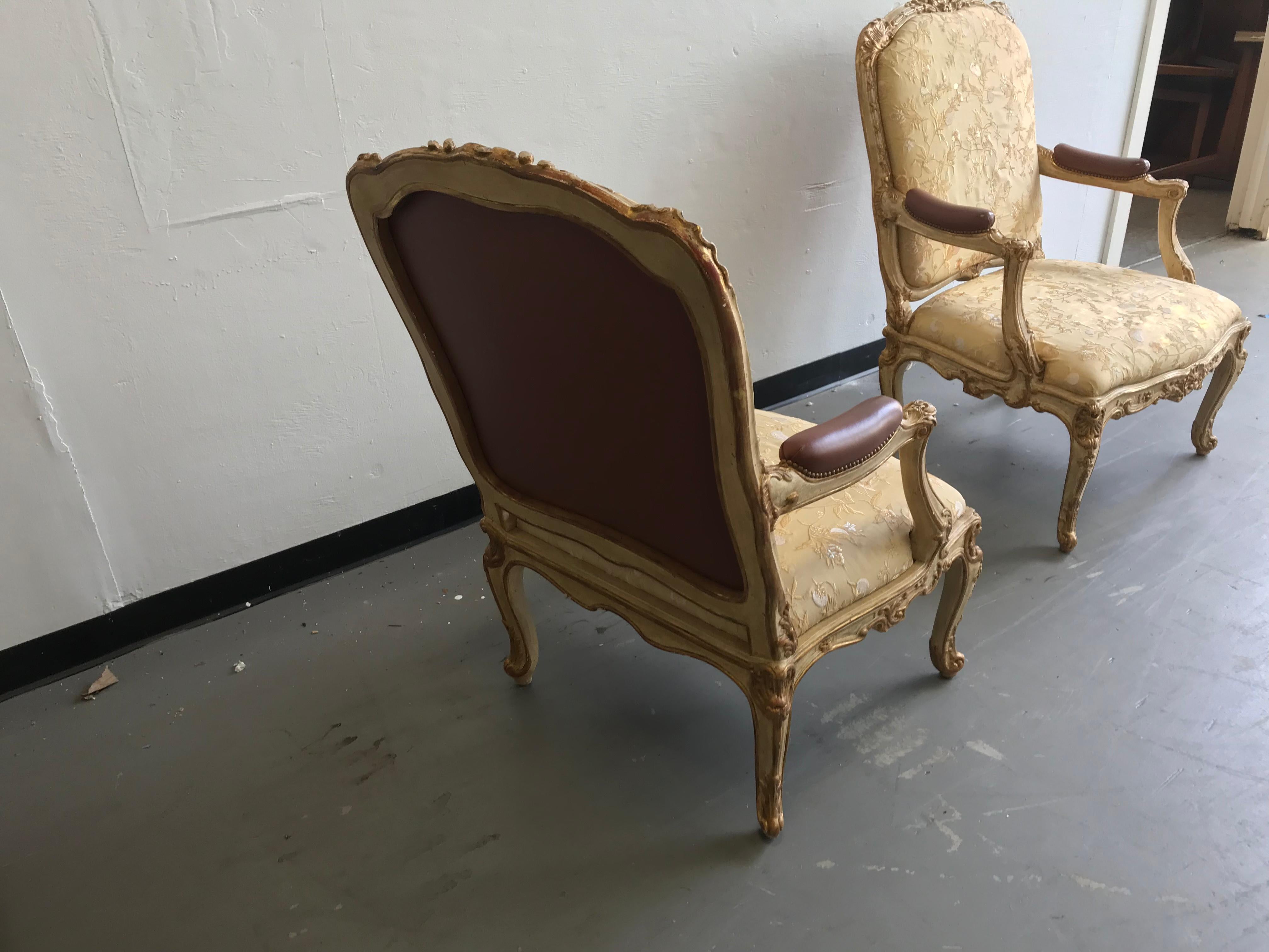This pair of oversized chairs are covered in a beautiful silk fabric. The fabric shows small signs of wear.