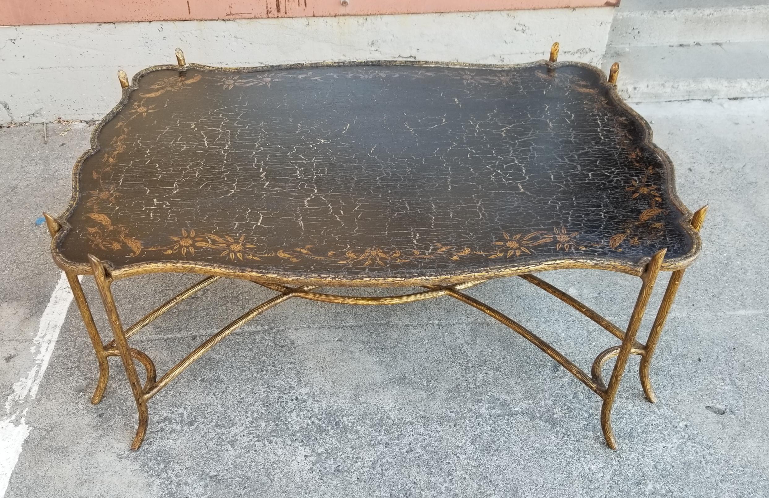 Fine Dennis and Leen coffee table with organic branch motif cast and gilt faux bronze iron base and rustic / distressed chinoiserie style painted wood top. Table top may be lifted from base as a large tray table or attached to base with wood screws