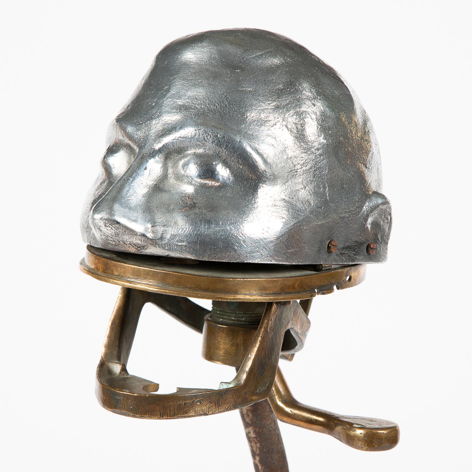 An early 20th century aluminum and bronze dental articulator or phantom head, mounted on an iron display stand, circa 1910.