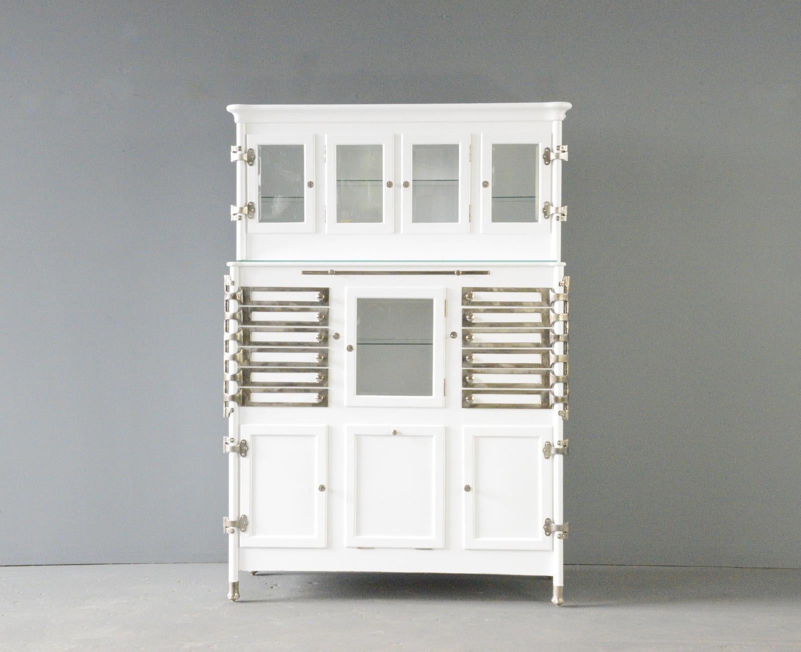 Dentists Cabinet Circa 1920s

- Made from pine with white paint
- Toughened glass top
- Nickel handles
- Original keys for the top and bottom cupboards
- German ~ 1920s
- 114cm wide x 44cm deep x 172cm tall

Condition Report

Fully restored and