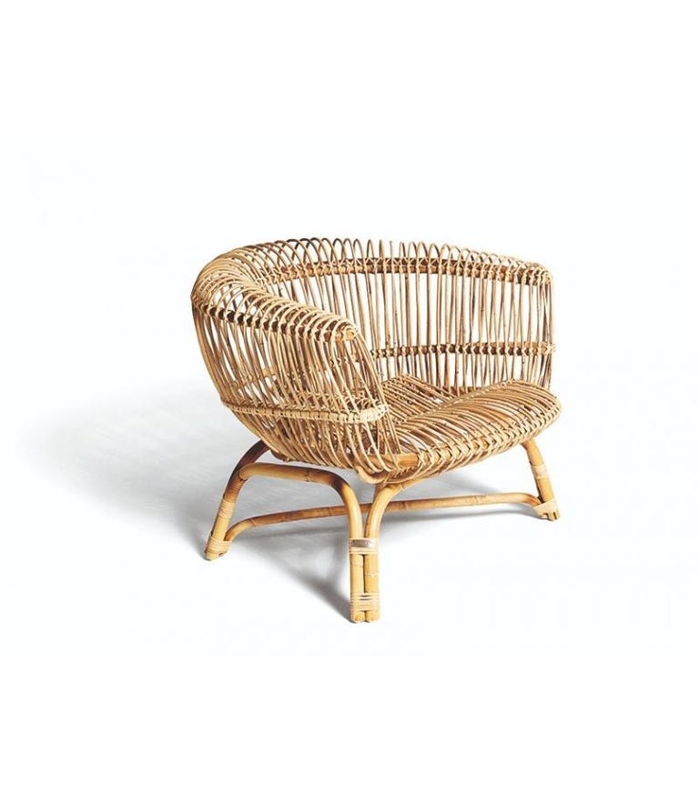 A re-edition of a beloved classic. This large, comfortable armchair designed by Paolo Tilche is made of rattan that is hand-tied by Bonacina1889 with rush bark. Each chair is one-of-a-kind, which makes it a precious and cherished piece. It brings a