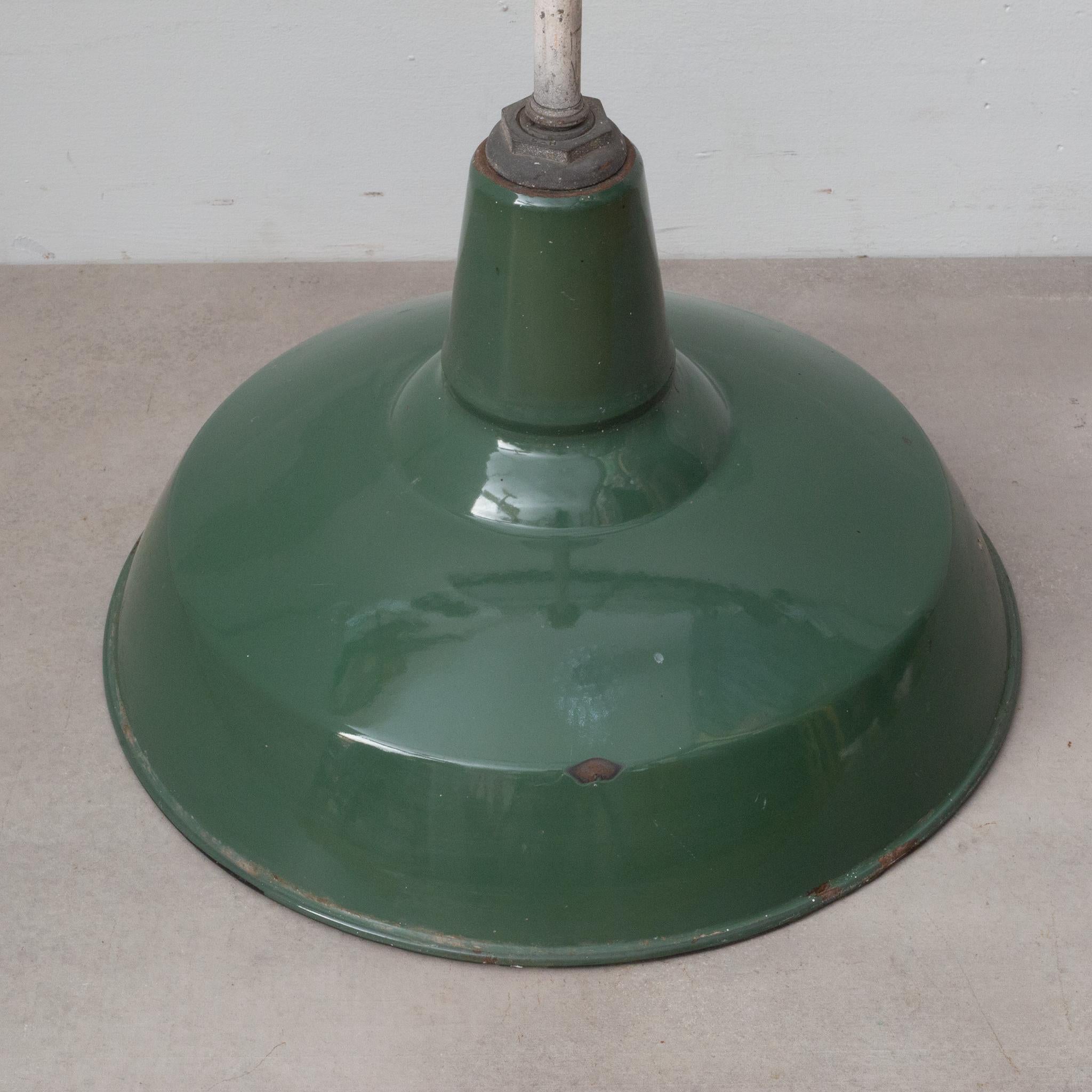 About:

Large one is available. Smaller one sold. 

Original large green enameled factory pendant light fixture with white porcelain interior and metal swivel joint canopies.

Creator: Benjamin Electric Mfg., Chicago.
Date of manufacture: