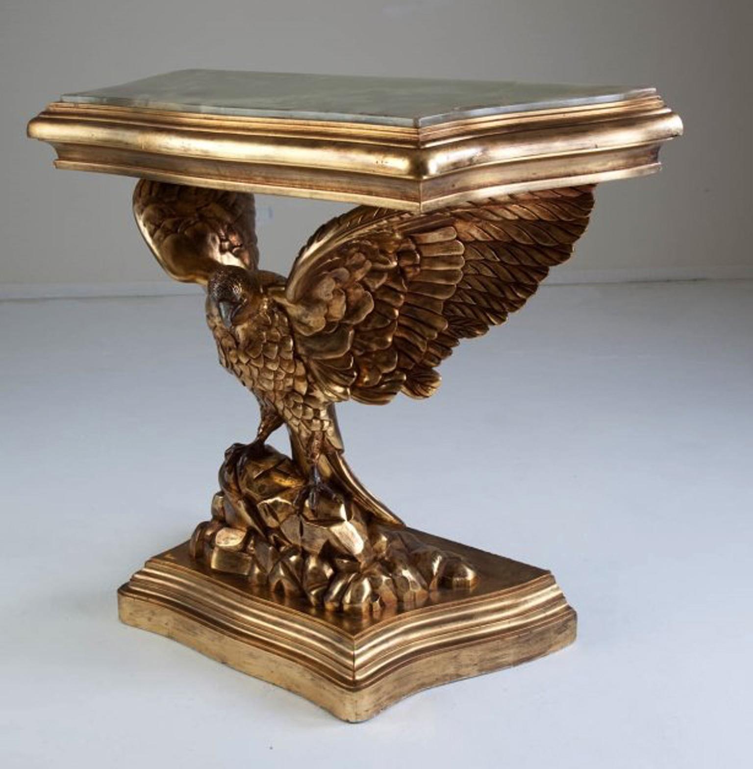 Impressive English George III style carved giltwood eagle-form console table with onyx top, 20th century.

The beautiful green onyx top is inset into a giltwood frieze, over a finely carved giltwood eagle with spread wings on rock-form base,