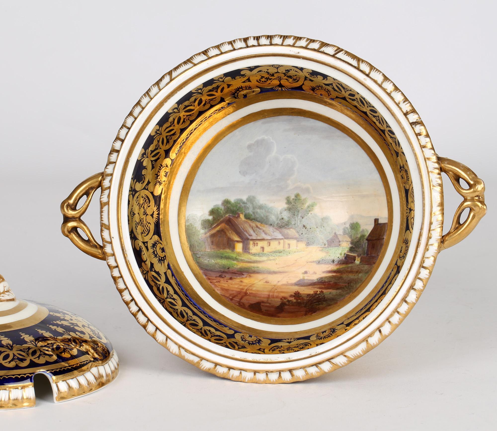 A very fine English Georgian twin handled lidded porcelain sauce tureen with a painted landscape attributed to Derby and dating from around 1820. The tureen stands raised on a rounded pedestal base with narrow stem the foot with a rope twist edge