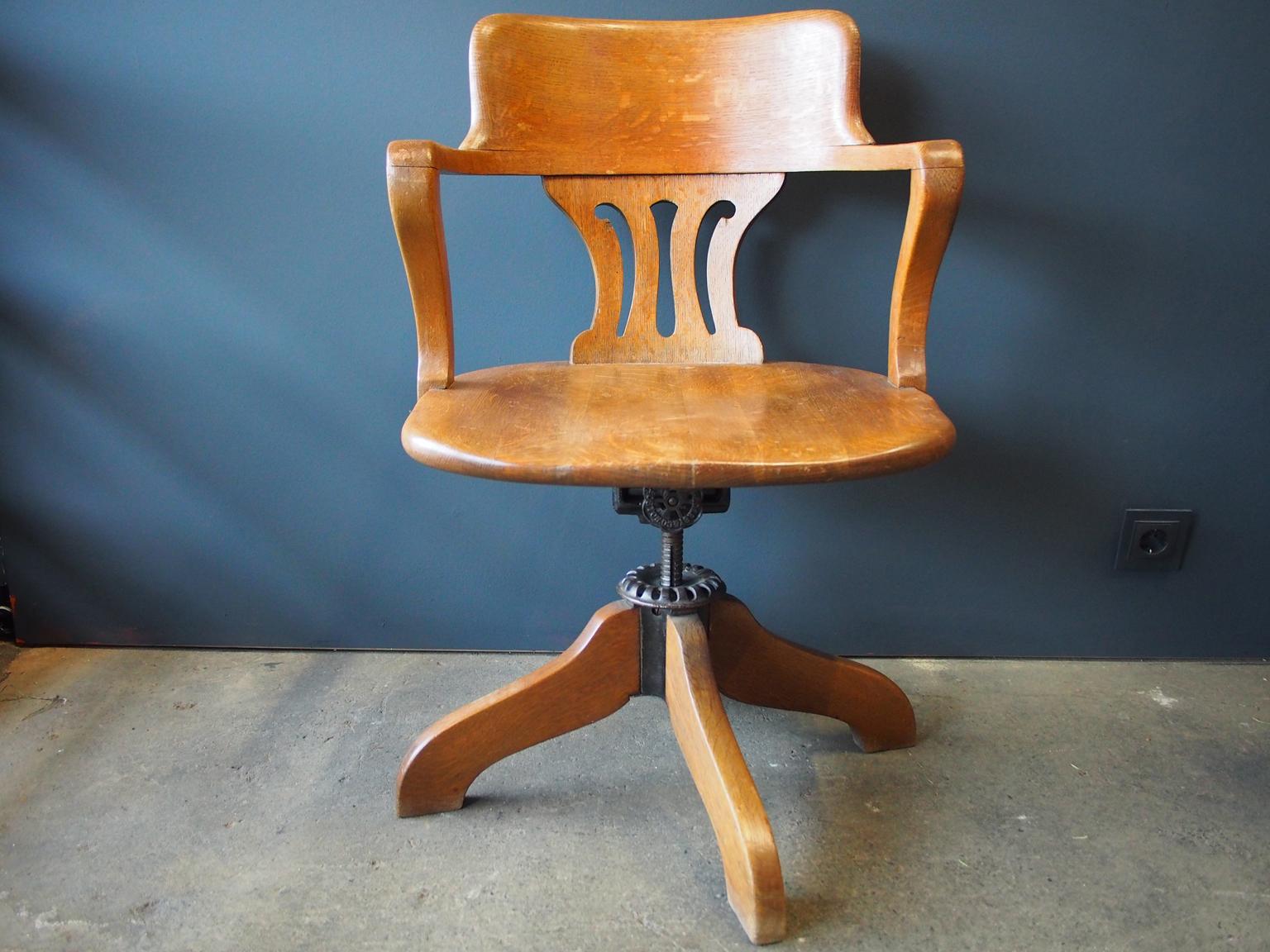 Beautiful office chair from the early 20th century. The armchair is height adjustable, swiveling and has a flexible backrest. Especially nice is the Art Deco shape in combination with the industrial screws.