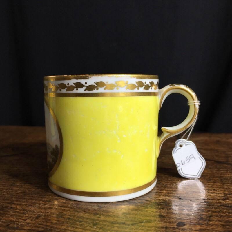 Derby coffee can by Thomas 'Jockey' Hill, superbly painted with a landscape roundel in gilt border on yellow ground, the rim and interior with a foliate gilt border.
Inscribed to the base in blue 