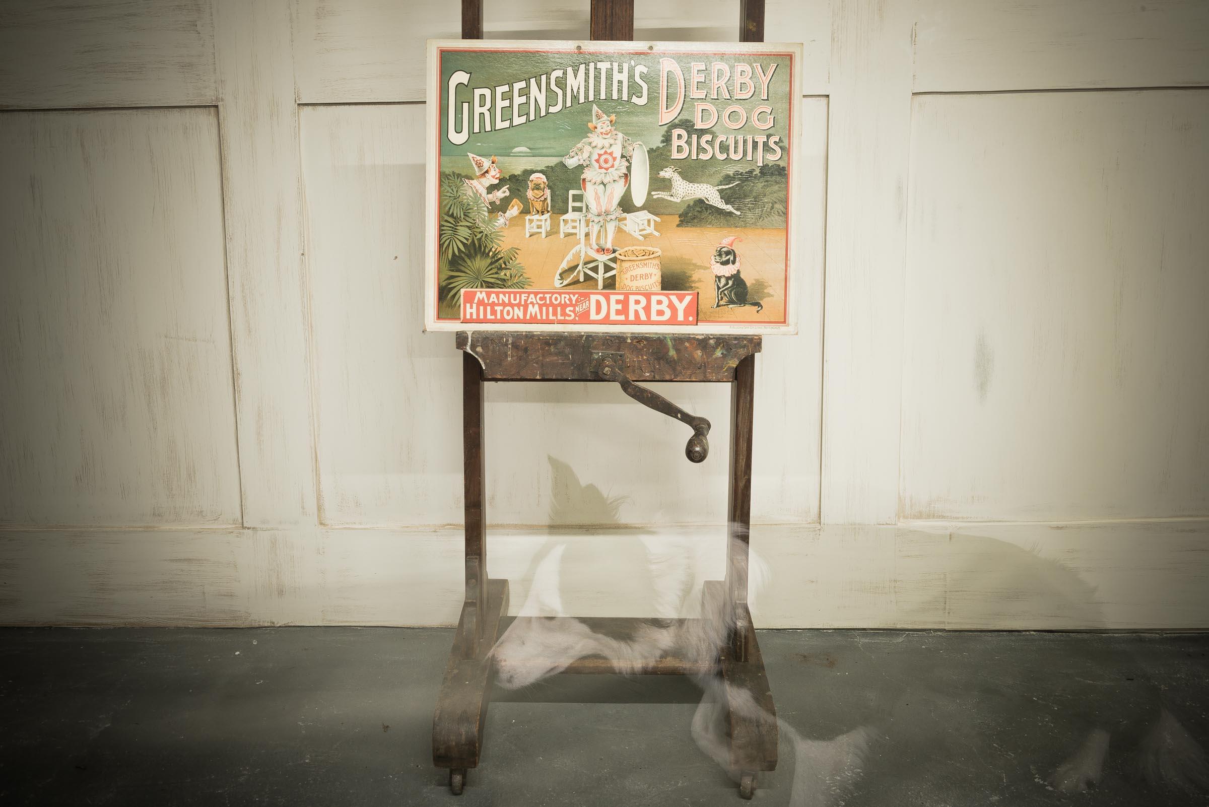 A Victorian c.1890 English advertising plaque representing Greensmith's Derby Dog Biscuits. A Color lithograph on heavy stock; approximately 28 3/4' wide by 18 1/2' tall; lithographed by R.H. Allen & Son, Nottingham; tied string hanger at the top; a