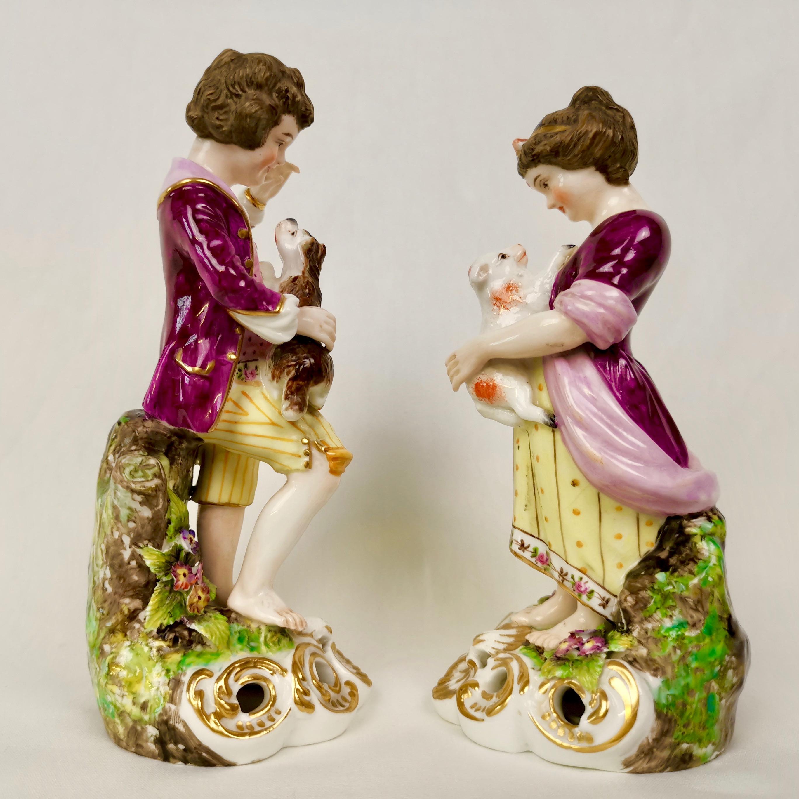 This is a set of two very charming figures portraying a boy and a girl playing with animals. It was made by the Derby King Street Factory (Sampson Hancock) in circa 1915 after a Georgian original of the 1760s. 

The Derby Porcelain Company became