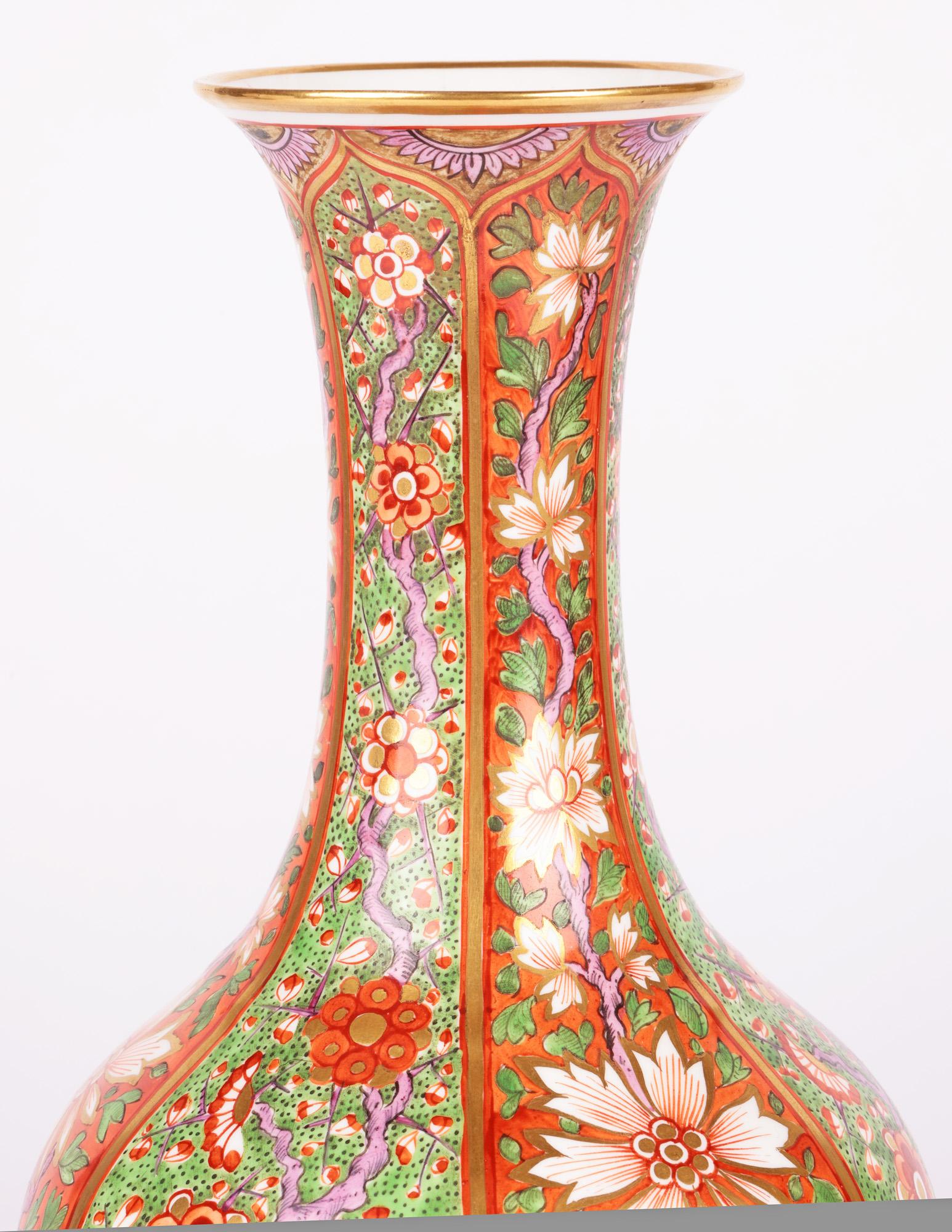A stunning and exceptional late Georgian floral painted porcelain bottle vase made by Derby and dating from around 1820. The large vase stands on a narrow round foot with slightly recessed base and has a round bulbous body with a tall slender neck