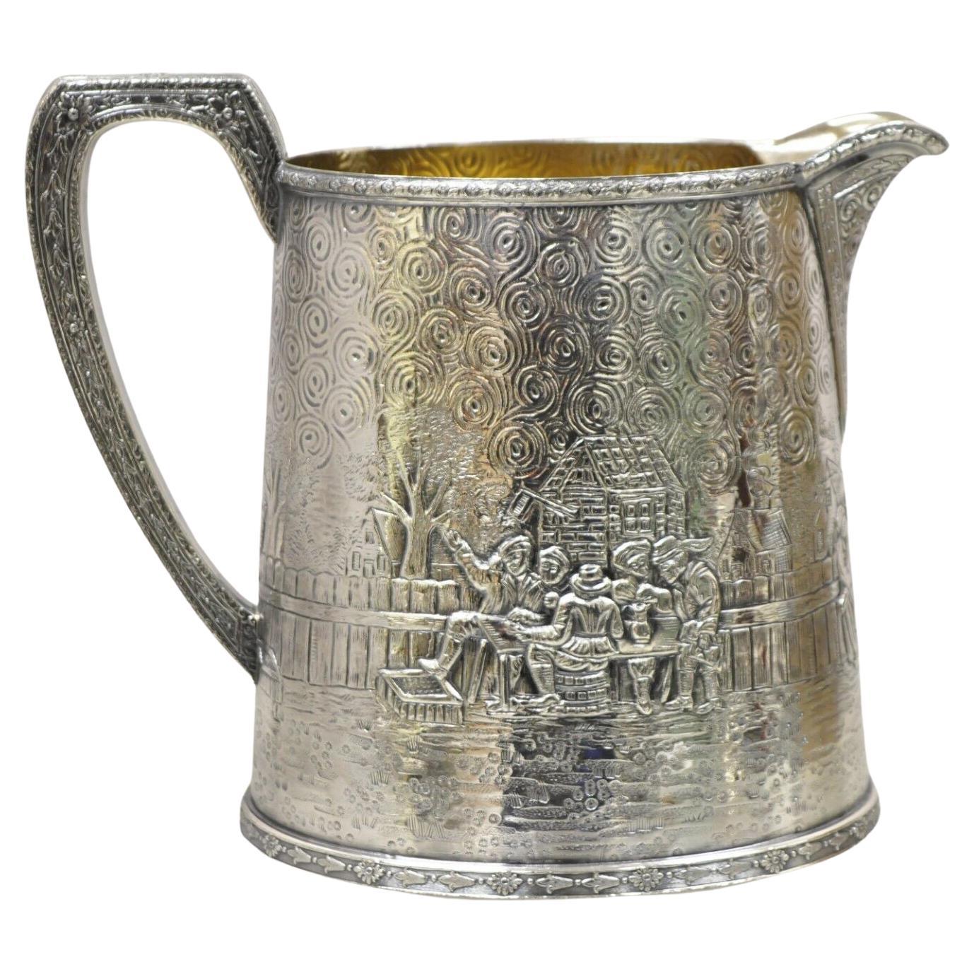 Derby S.P. Co International Figural Repousse Village Silverplate Water Pitcher For Sale