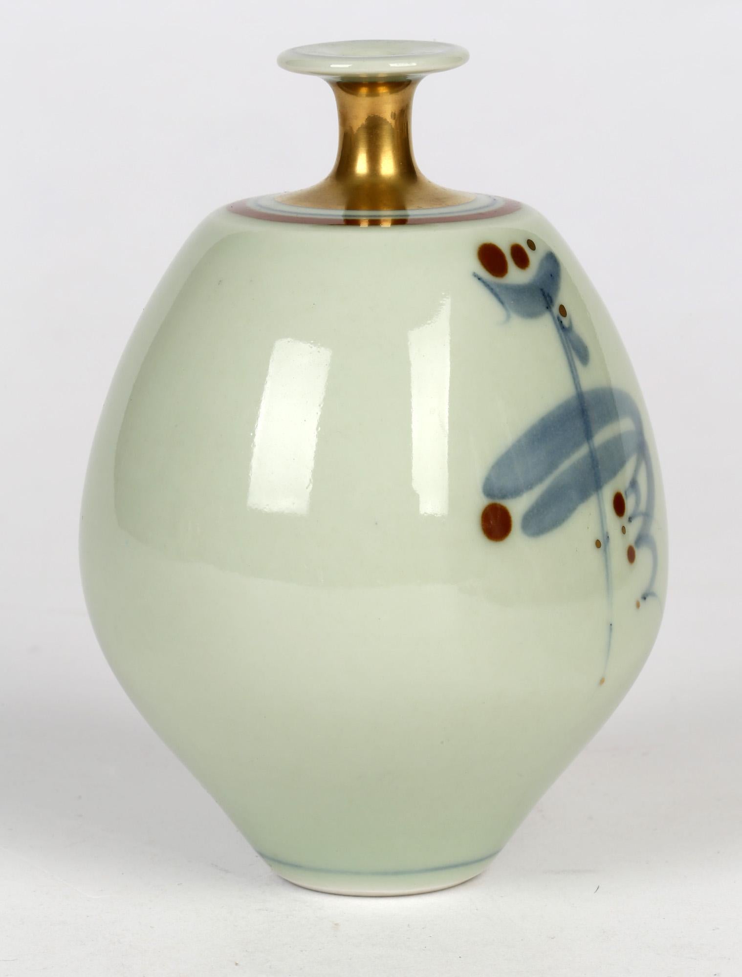 A good and finely made studio pottery porcelain bottle vase of slightly compressed form decorated with a stylized brush pattern on a cleladon glazed ground by Derek Clarkson (1928-2013) dating from 1999. The vase of rounded bulbous shape with