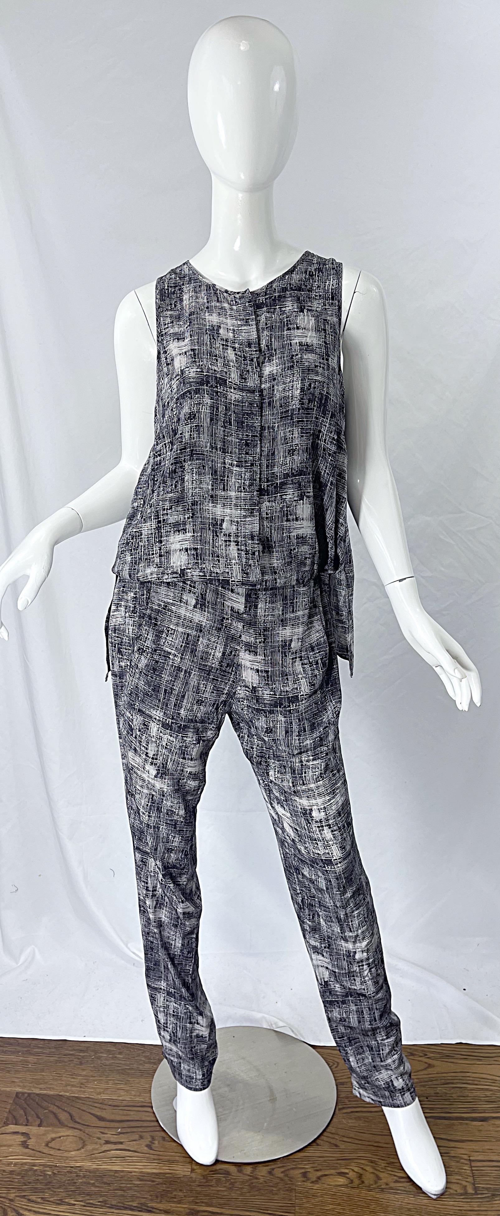 Chic 2000s DEREK LAM black and white silk jumpsuit ! Features an Avant Garde style wing back. Hidden button up the front. Slim leg with pockets at each side of the hip. Abstract print in black and white gives off a grey color. Can easily be dressed